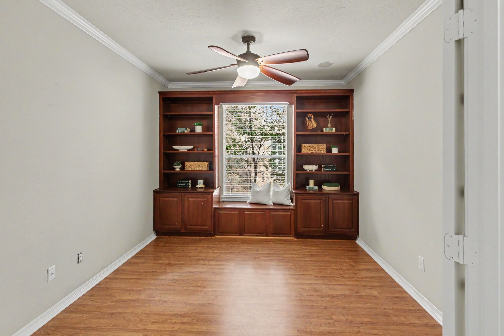 The study with built-in shelves and a storage bench perfect for reading. The double french doors (not shown), close off the study for complete privacy.