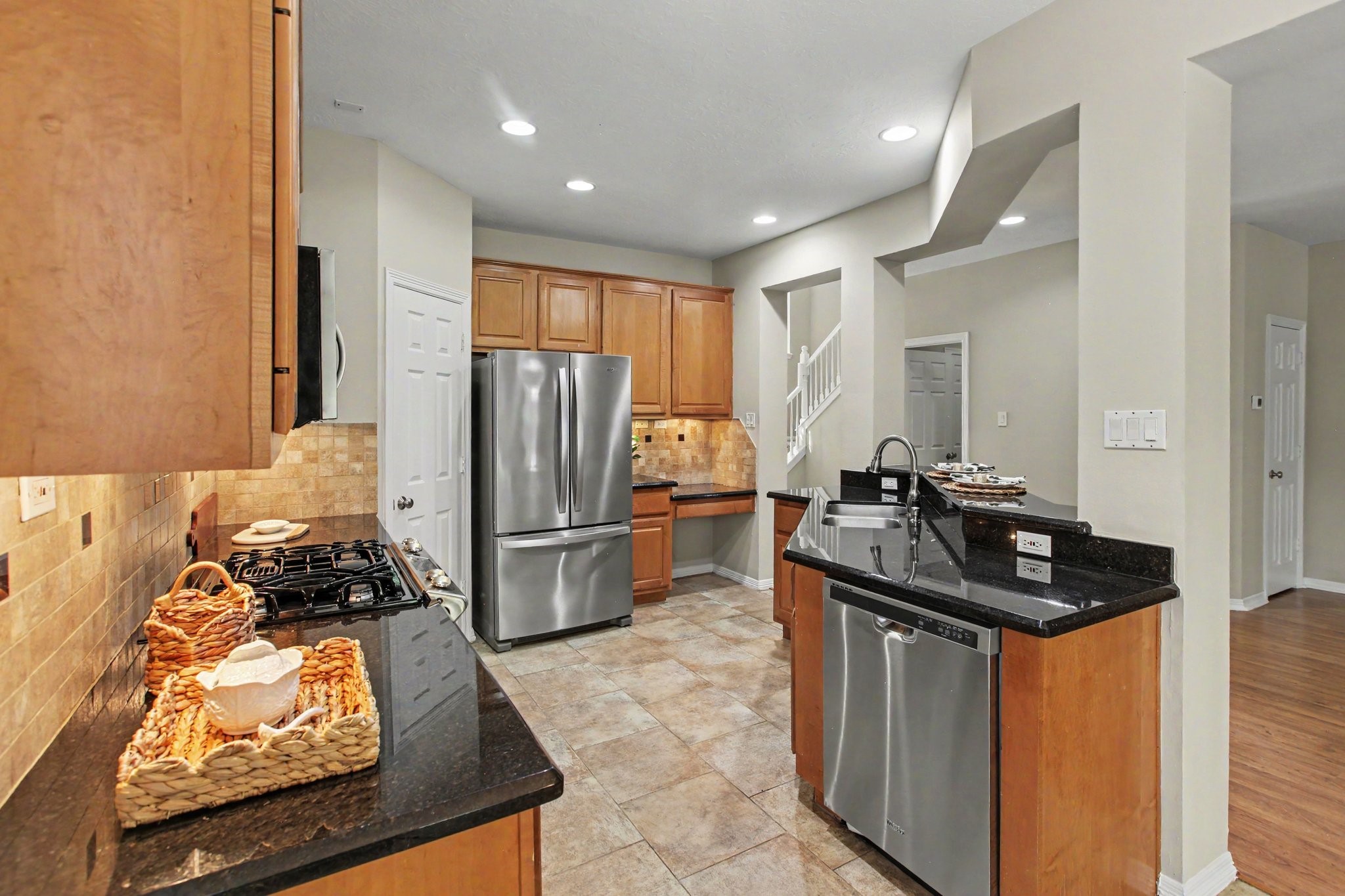 The kitchen has an abundance of counter space (including a working desk) and is conveniently located near the breakfast nook and living room.