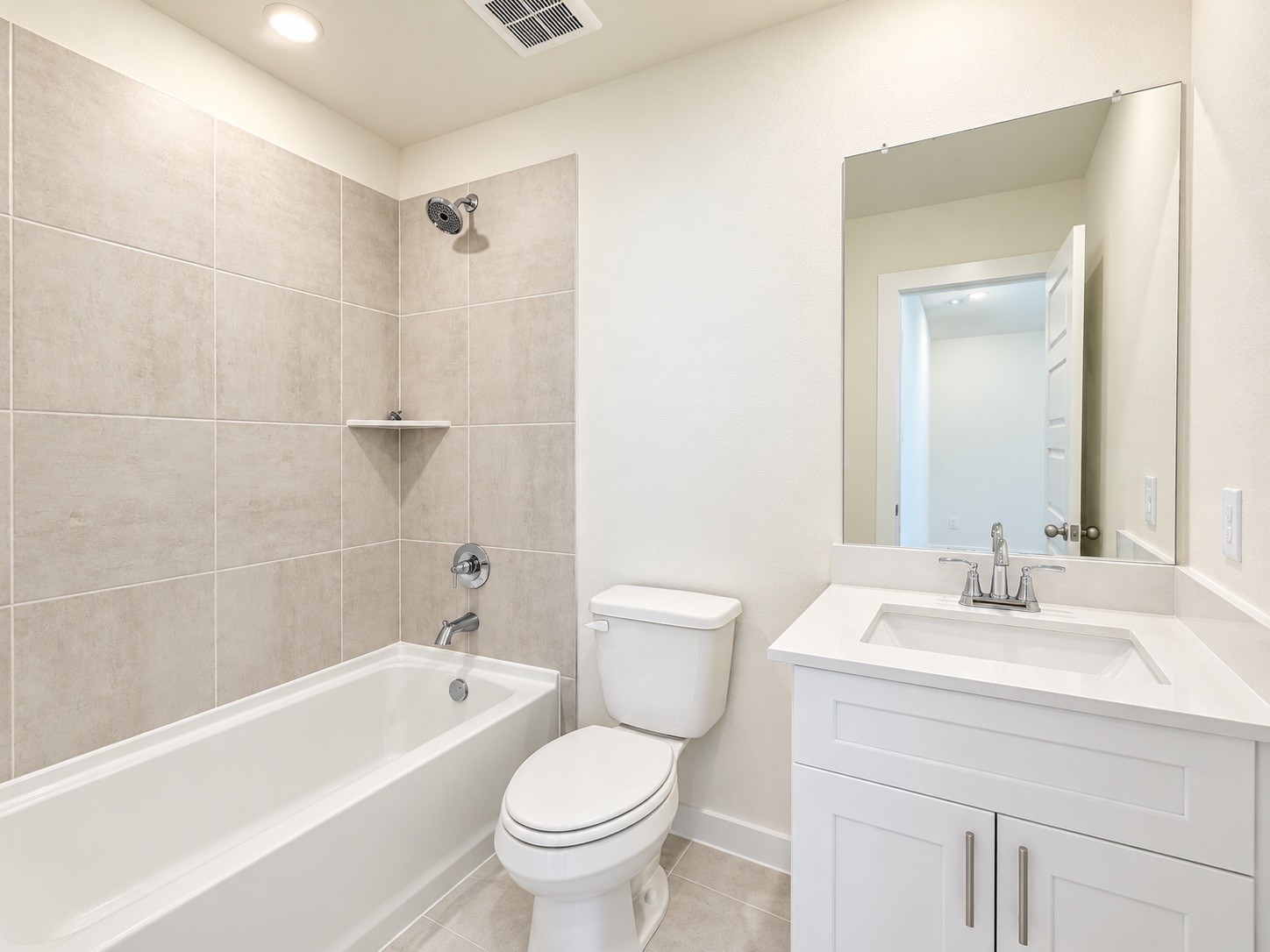 Modern bathroom featuring a vanity and spacious shower/bathtub combo