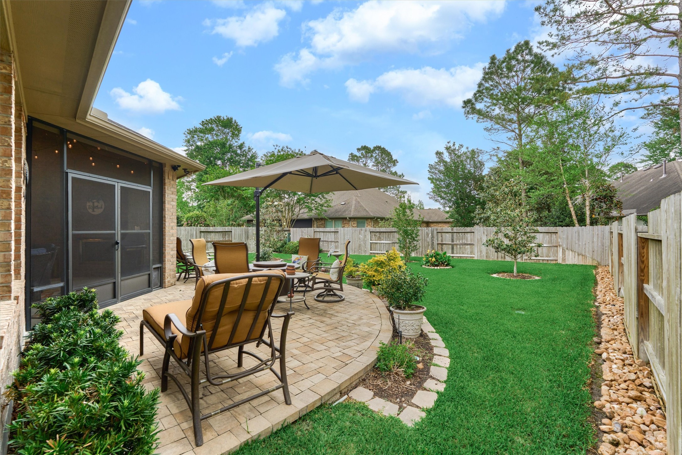 Truly a picturesque backyard with impeccable landscaping and timeless patio area.