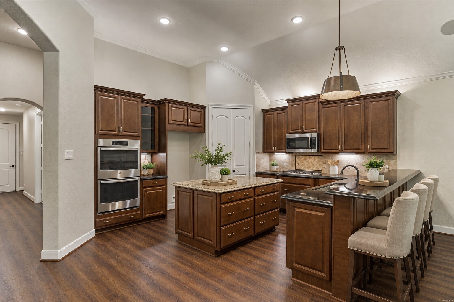*This is a virtually staged photo* The chef of the family will love the double ovens, center island, and gas cooktop.