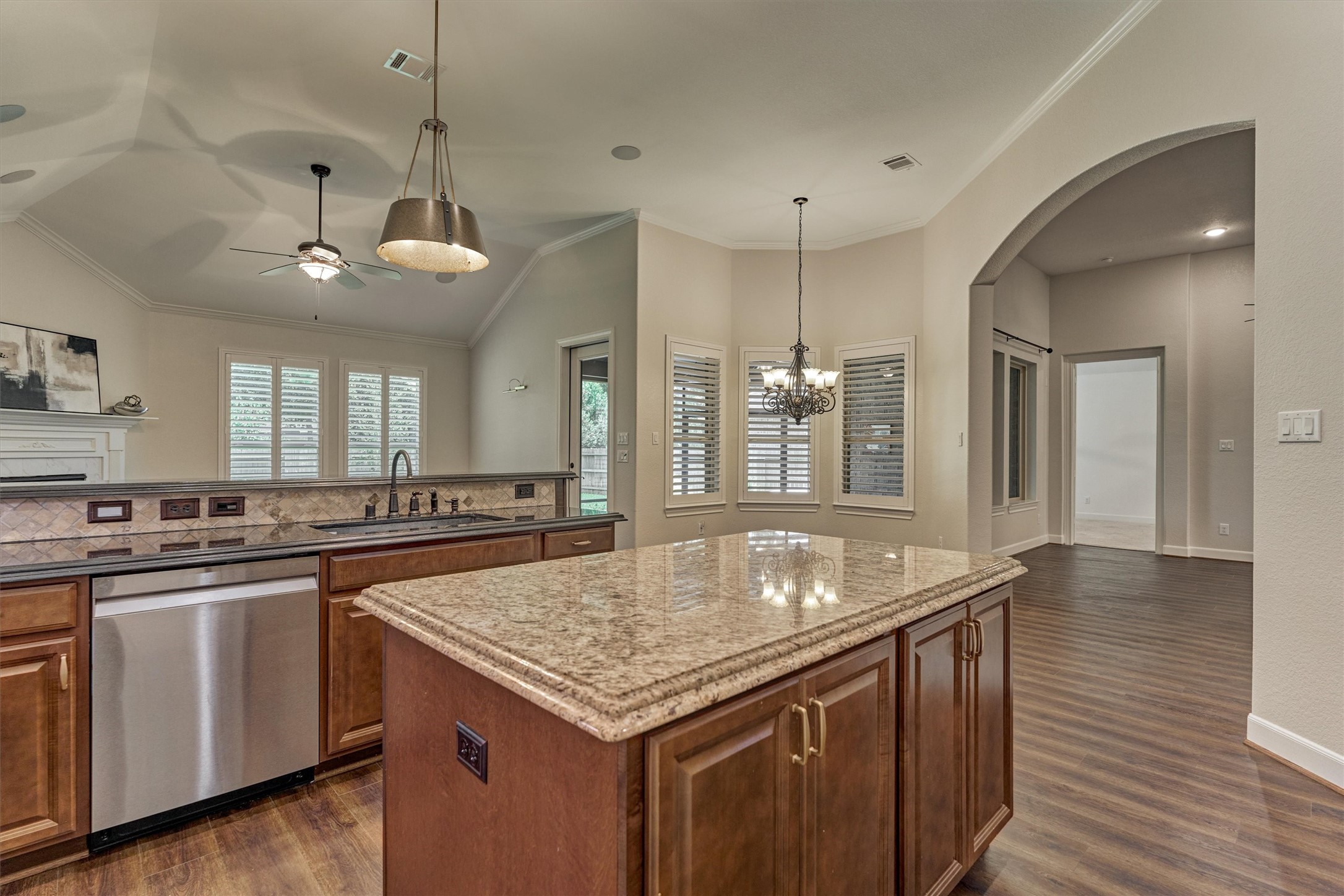 This angle showcase the blended living spaces and displays that the kitchen is the hub of the home.