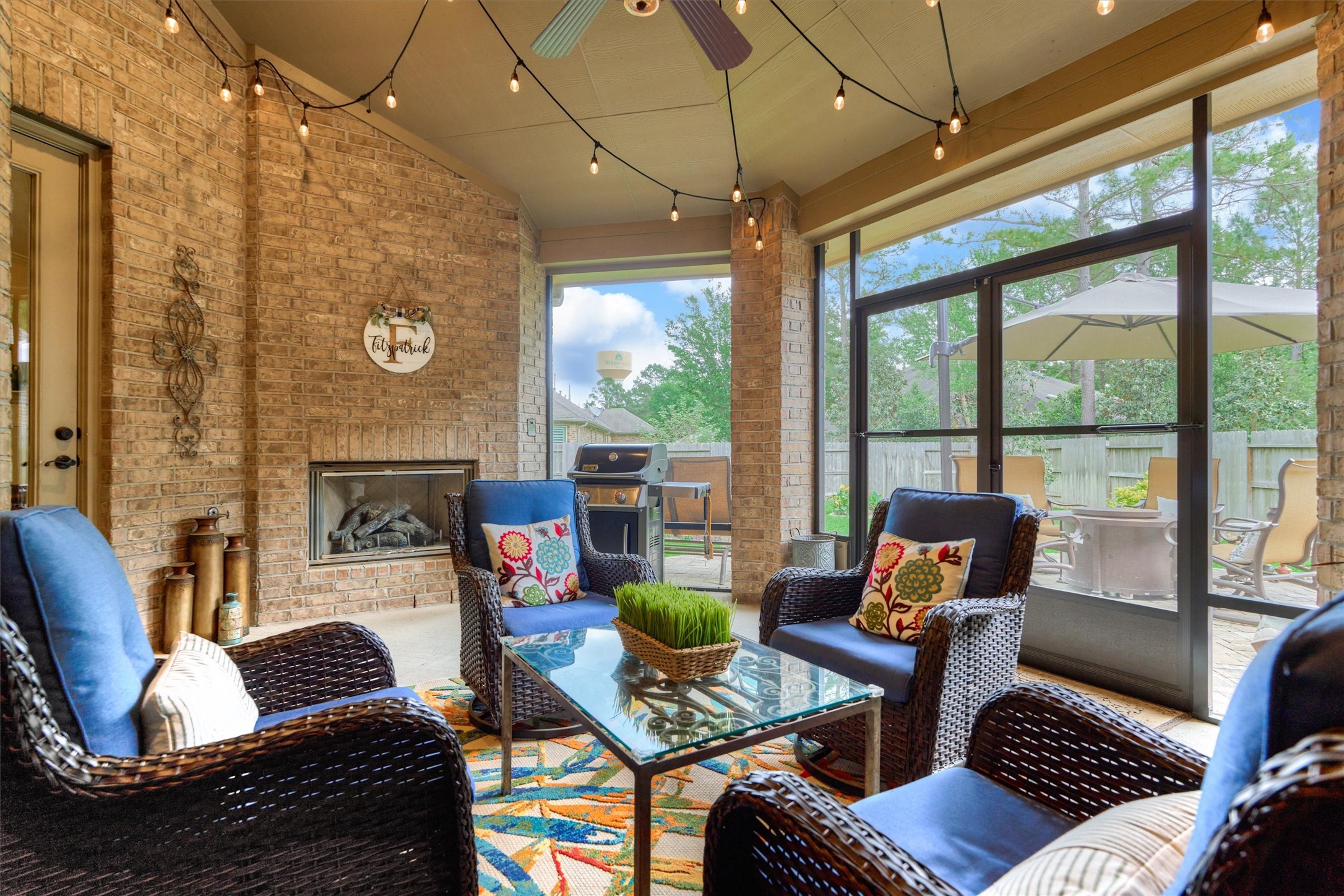 Savor a shady retreat with fireplace and serene patio views of the tranquil backyard retreat.