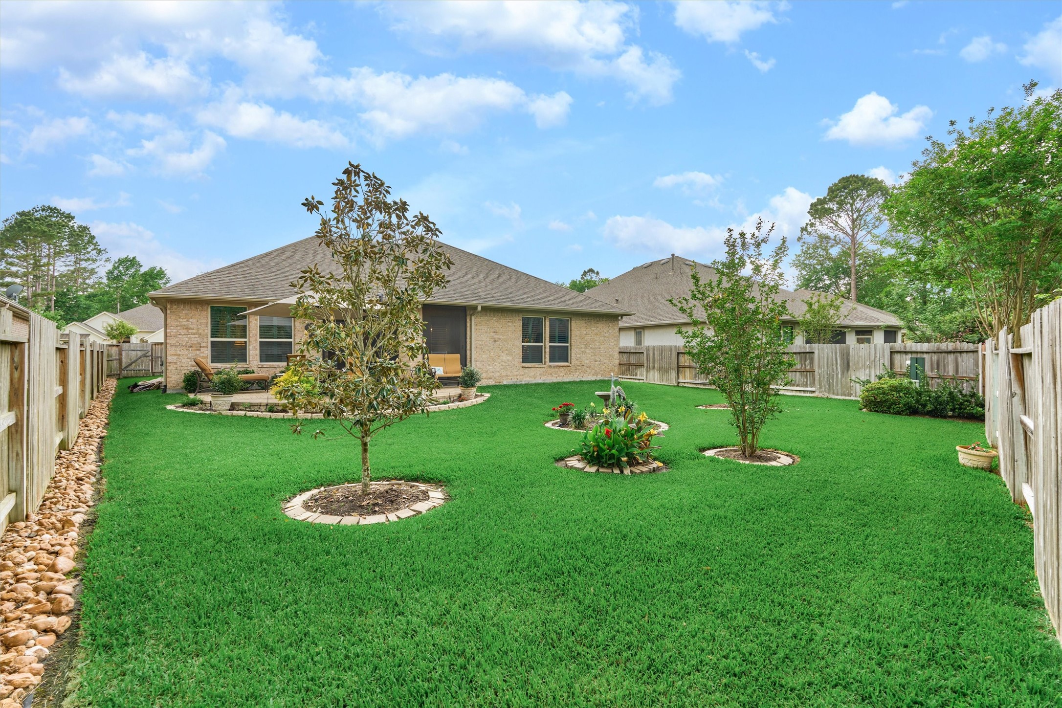 What a majestic backyard! Low-maintenance yard that appears like green carpet - well manicured and picture perfect.
