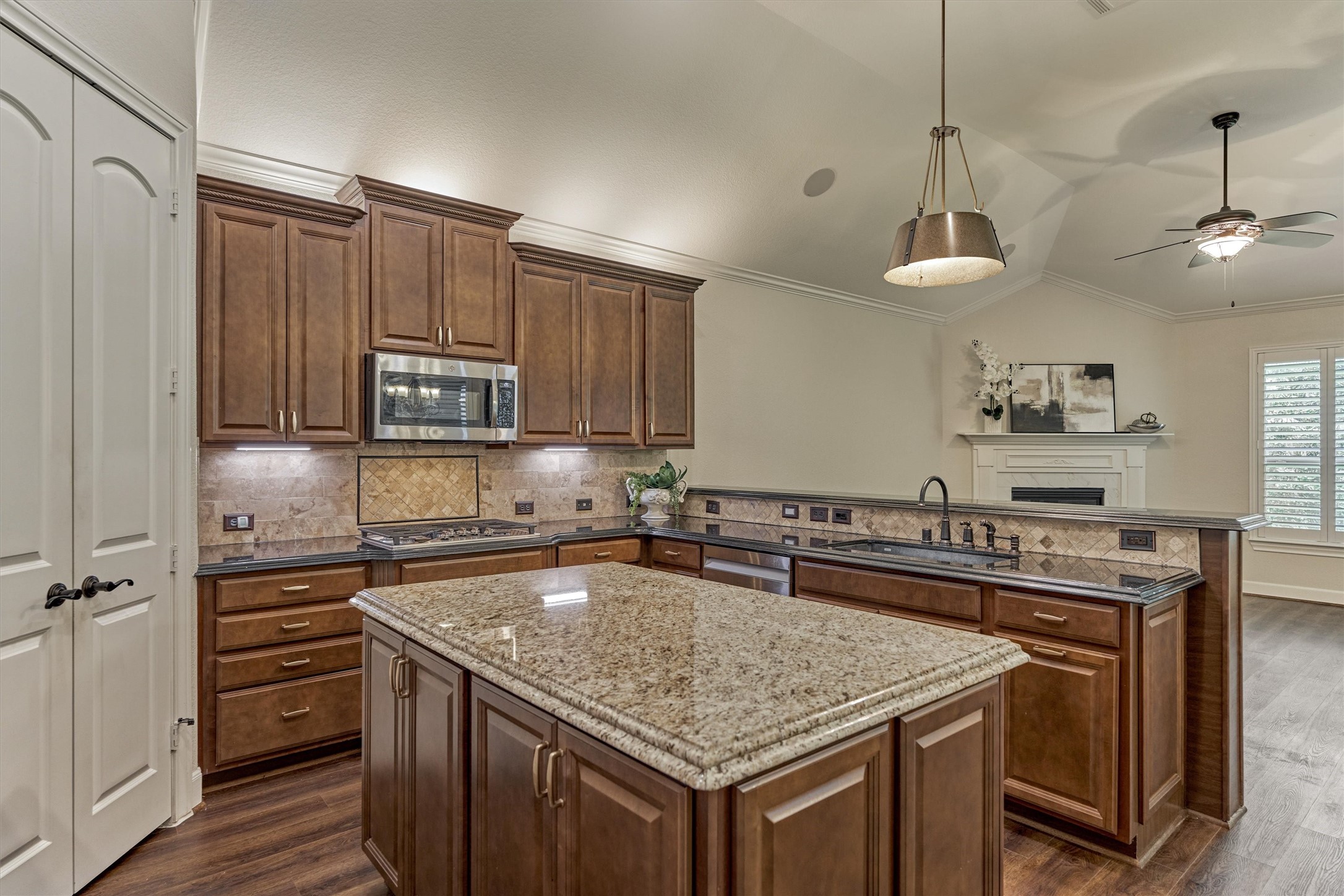 The center island offers additional prep space and a beautiful granite color that adds contrast to the kitchen.