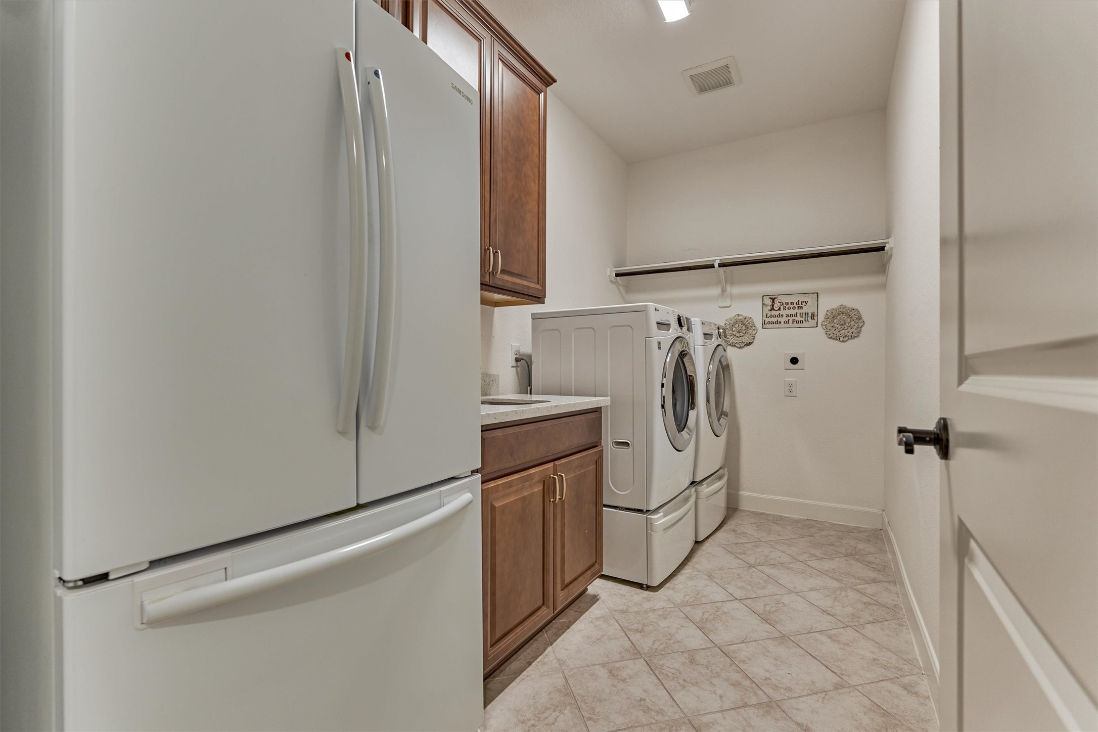 What an incredible utility room with a sink and awesome storage capacity.