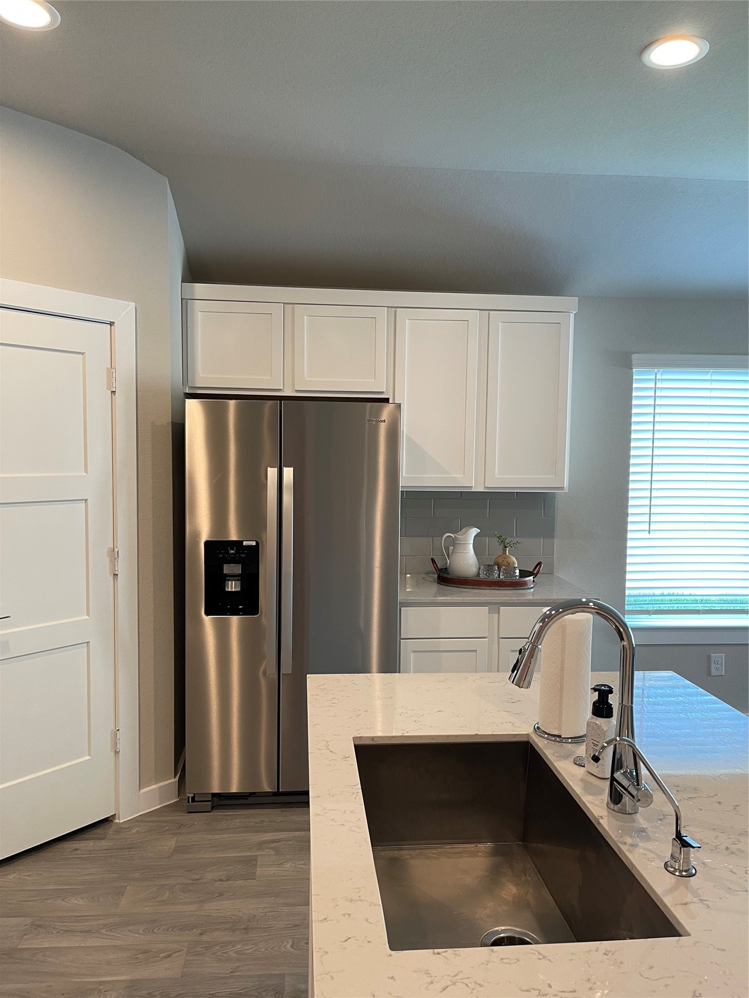 Modern kitchen with sleek stainless steel appliances, elegant white cabinetry, and a spacious quartz countertop with an undermount sink. Modern kitchen with sleek stainless steel appliances, elegant white cabinetry, and a spacious quartz countertop with an undermount sink.