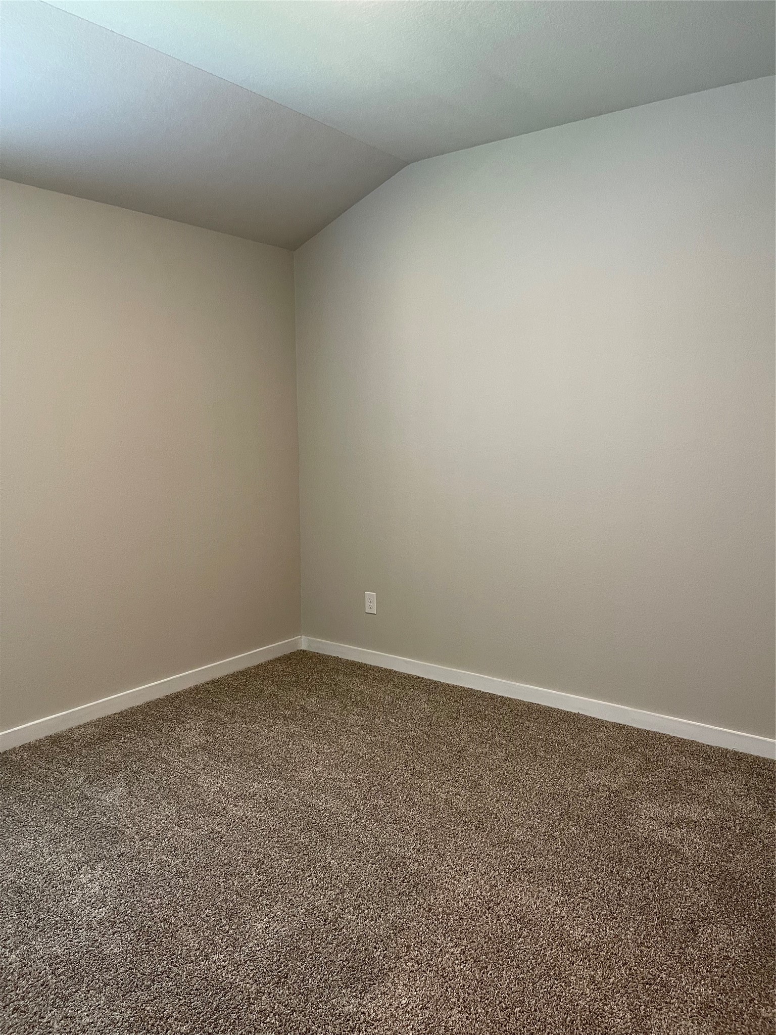 Cozy room with soft carpet flooring and neutral walls, perfect for personalization.