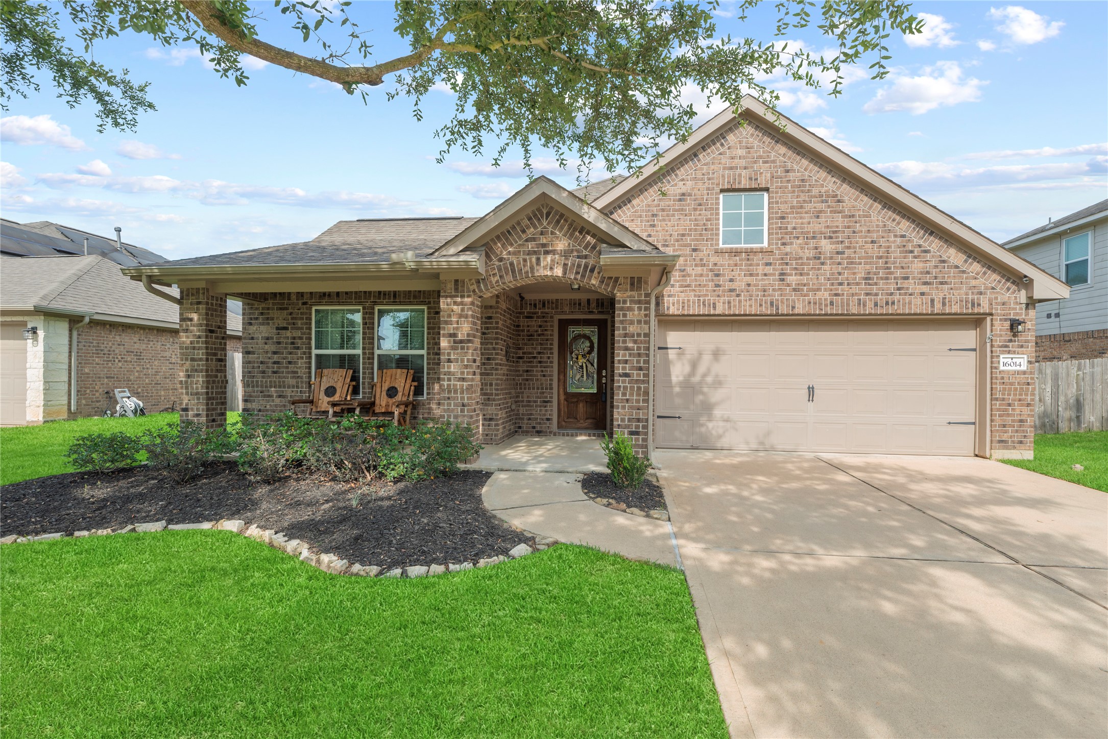 One-story home with a 2-car attached garage, double-wide driveway and charming front porch.