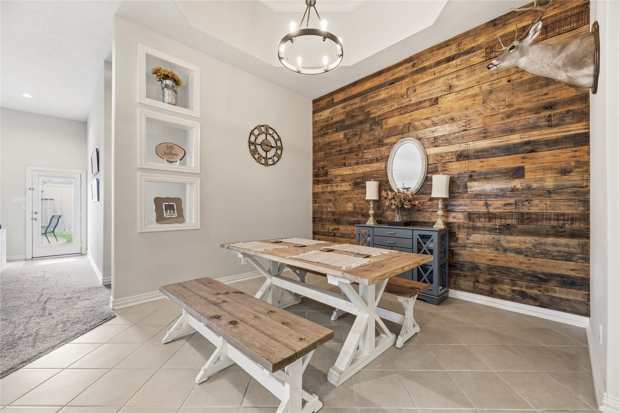 Stunning dining area with a striking wood accent wall. Stunning dining area with a striking wood accent wall.