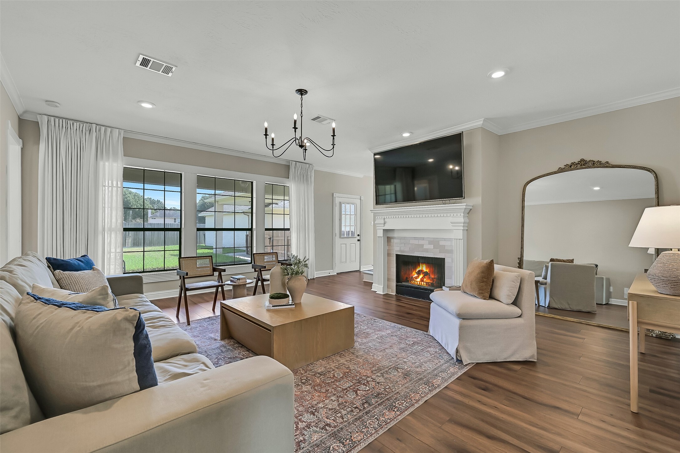 Walls of windows fill the family room with natural light while offering views of the expansive backyard. A gas-log fireplace provides a welcoming focal point, and the open connection to the breakfast area makes the layout ideal for gathering with family and friends.