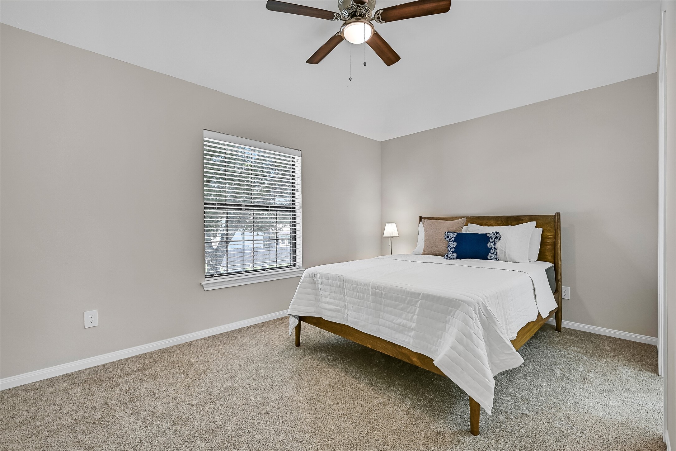 One of three secondary bedrooms upstairs, this spacious room offers neutral carpet, a ceiling fan, abundant natural light, & a convenient Jack & jill style bathroom. Each secondary bedroom also features its own walk-in closet.