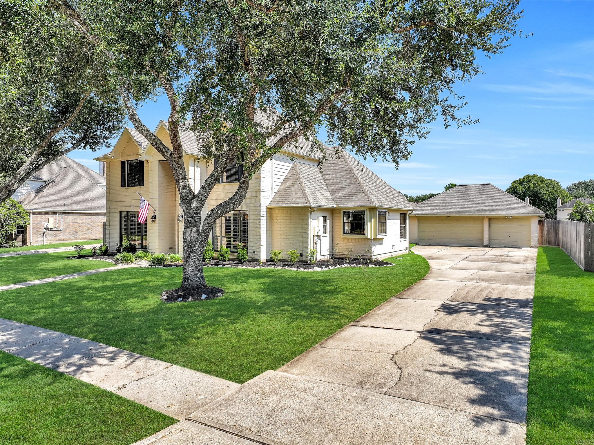 A sweeping driveway leads to the detached 3-car garage, providing generous parking while preserving the homes attractive front elevation. Mature trees, established landscaping & a broad front lawn create a welcoming setting in the heart of Friendswood.