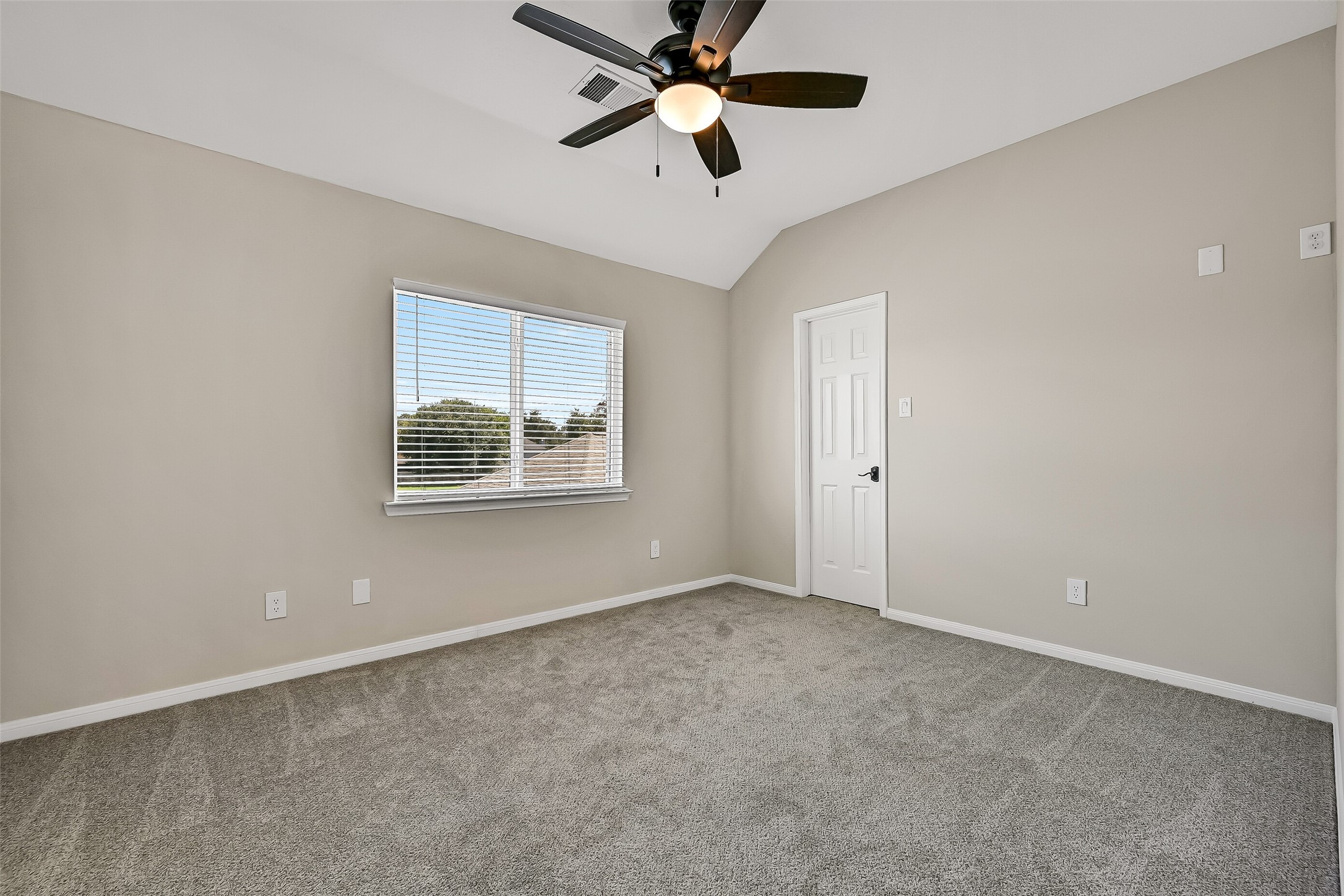 The third upstairs bedroom is another bright, comfortably sized space with neutral carpet, ceiling fan, and a walk-in closet. With three bedrooms, two full baths and a gameroom upstairs, the floor plan offers excellent separation from the primary suite.