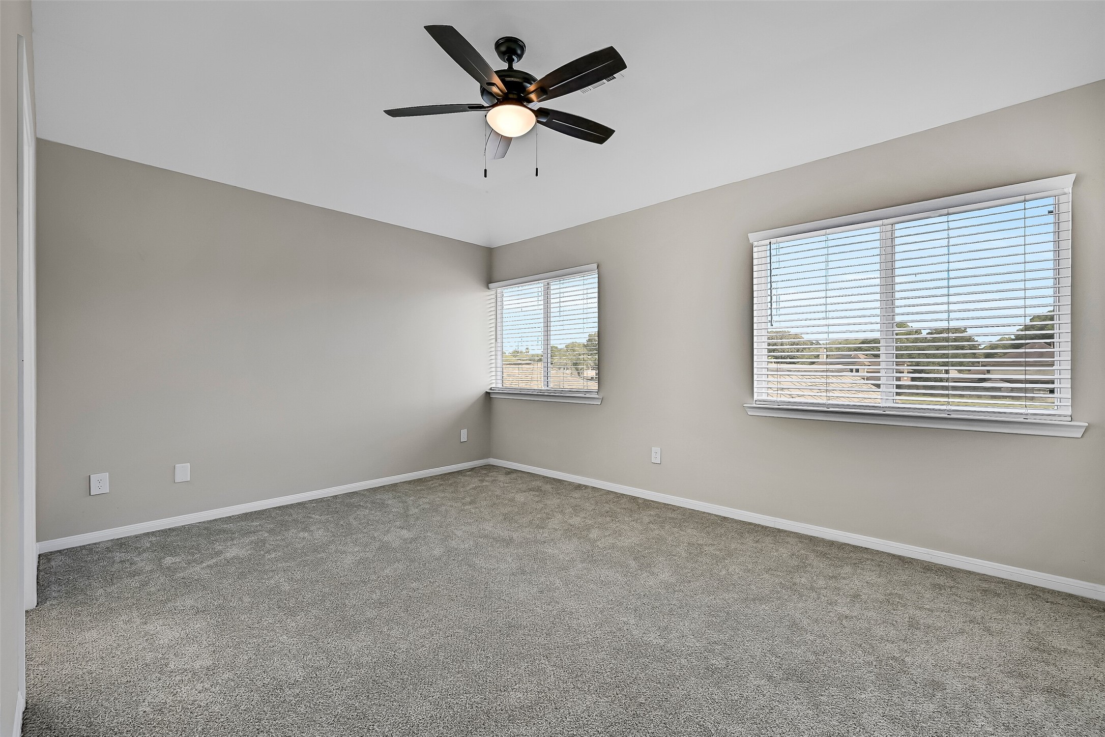 On the opposite side of the Jack & Jill bath, the second secondary bedroom offers generous dimensions, a vaulted ceiling, ceiling fan & windows on two walls for abundant natural light. A walk-in closet provides plenty of additional storage.