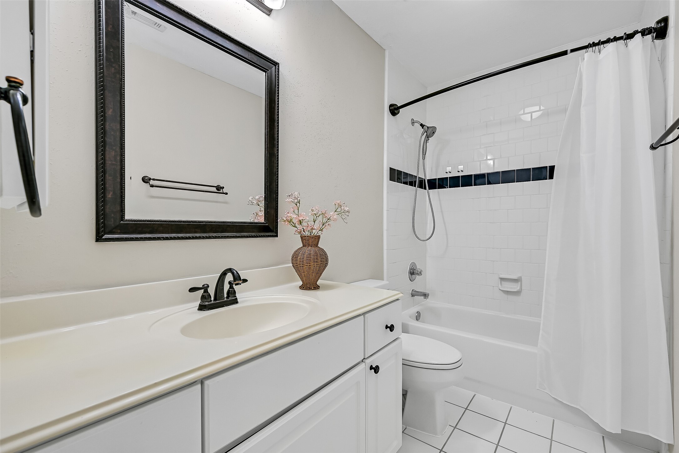 A second full upstairs bathroom serves the secondary bedrooms and gameroom. Neutral finishes, generous vanity storage and a tub/shower combination complete the practical second-floor layout.
