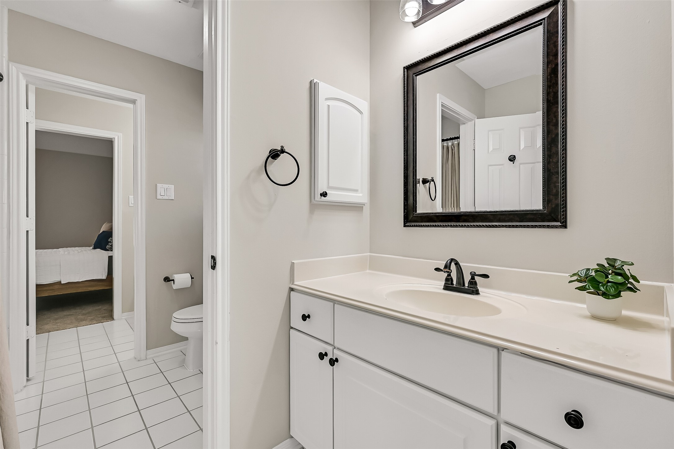 The convenient Jack & Jill bath connects two upstairs bedrooms and features separate vanity areas for added privacy and function. A shared central space includes the tub/shower and toilet, allowing both vanity areas to be used independently.