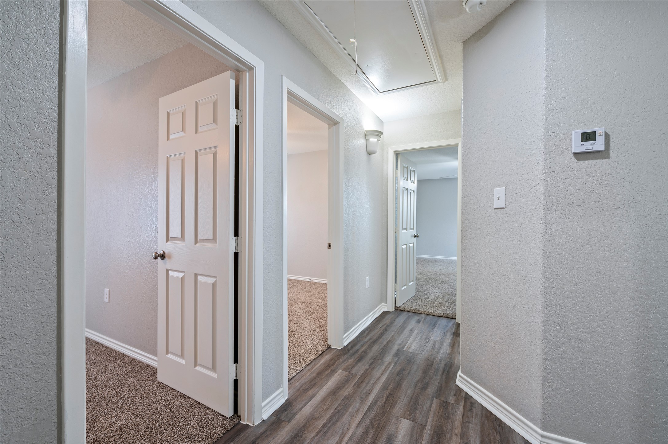 Hallway leads to the bedrooms and baths.