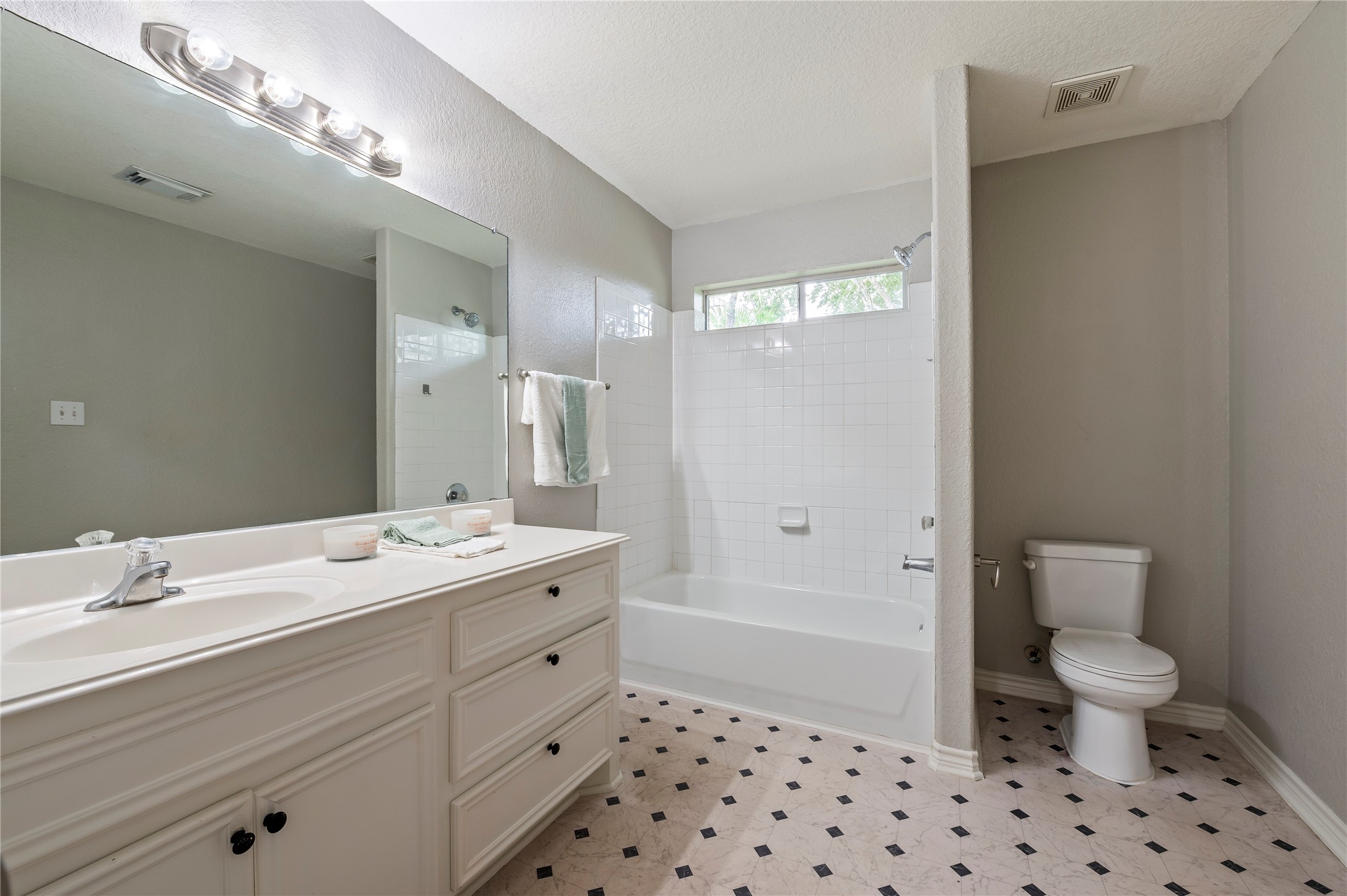 Spacious primary bath with large vanity and shower/tub combo.