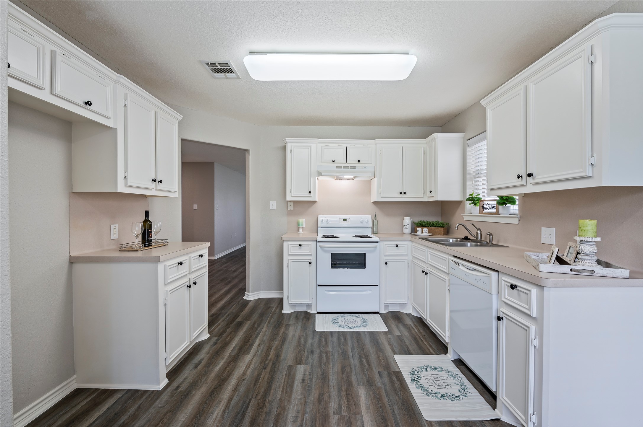 Spacious kitchen with ample natural lighting.