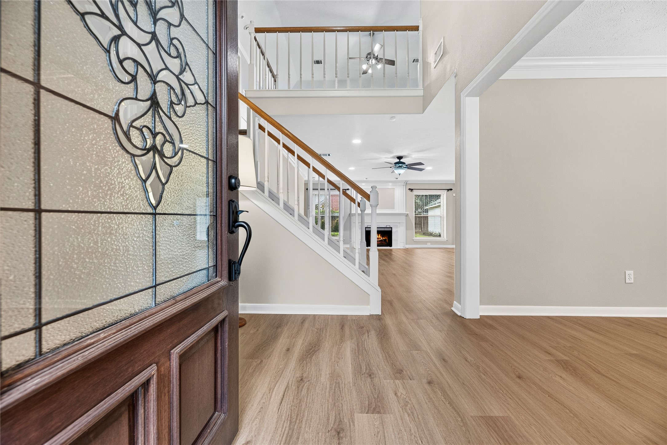 From the foyer, the formal dining room sits just to the right, offering a lovely setting for holiday dinners and elegant gatherings, while the spacious living room directly ahead invites you to settle in with a romantic gas-log fireplace and wall of custom built-ins. Fresh neutral paint and updated LVP flooring flowing throughout the 1st floor create a polished, cohesive feel throughout. From the foyer, the formal dining room sits just to the right, offering a lovely setting for holiday dinners and elegant gatherings, while the spacious living room directly ahead invites you to settle in with a romantic gas-log fireplace and wall of custom built-ins. Fresh neutral paint and updated LVP flooring flowing throughout the 1st floor create a polished, cohesive feel throughout.