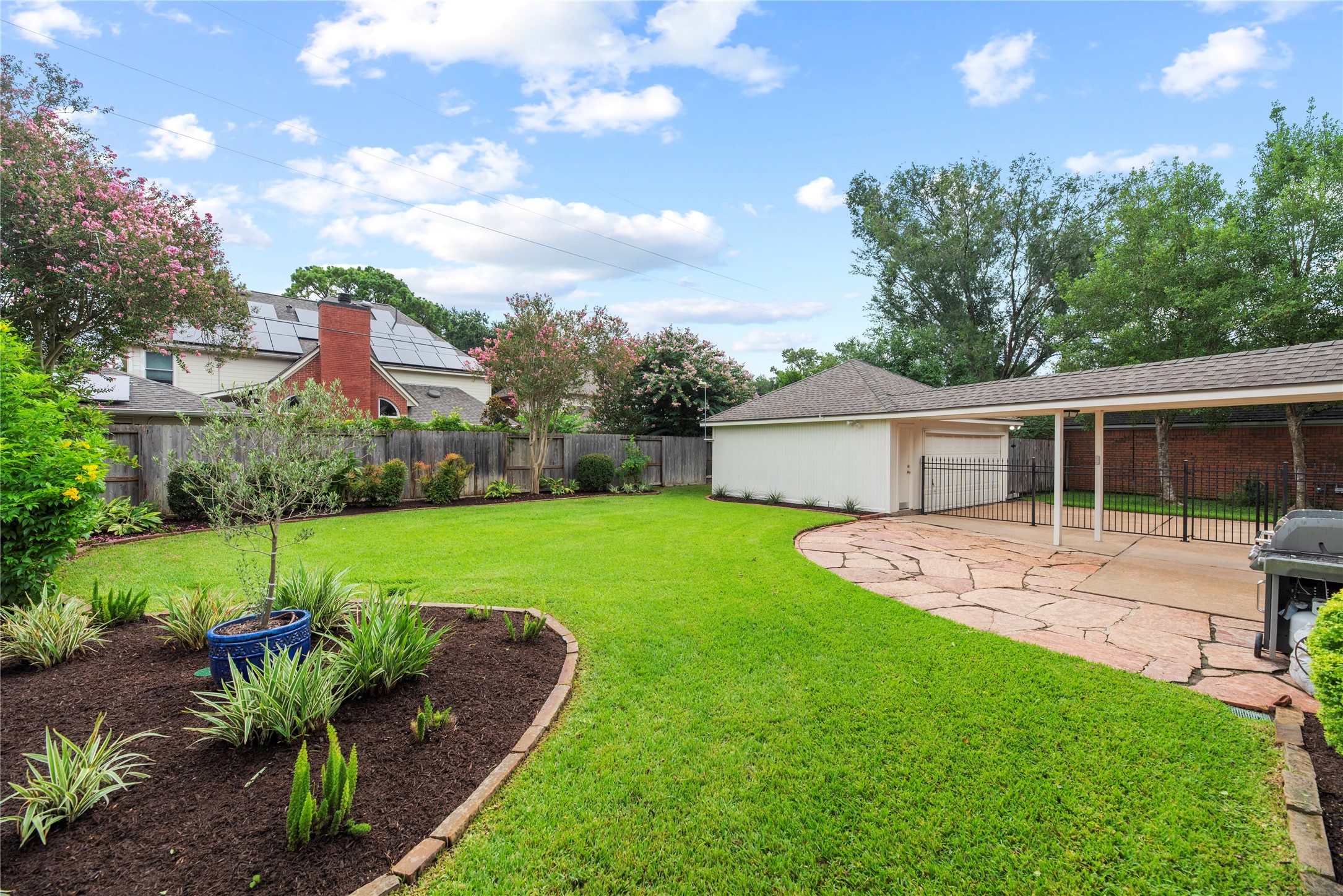 The expansive flagstone patio surrounded by mature landscaping creates an incredible setting for weekend cookouts, outdoor dining and evenings spent relaxing with friends under the open sky. This yard is fully equipped with an automatic sprinkler system and French drains.