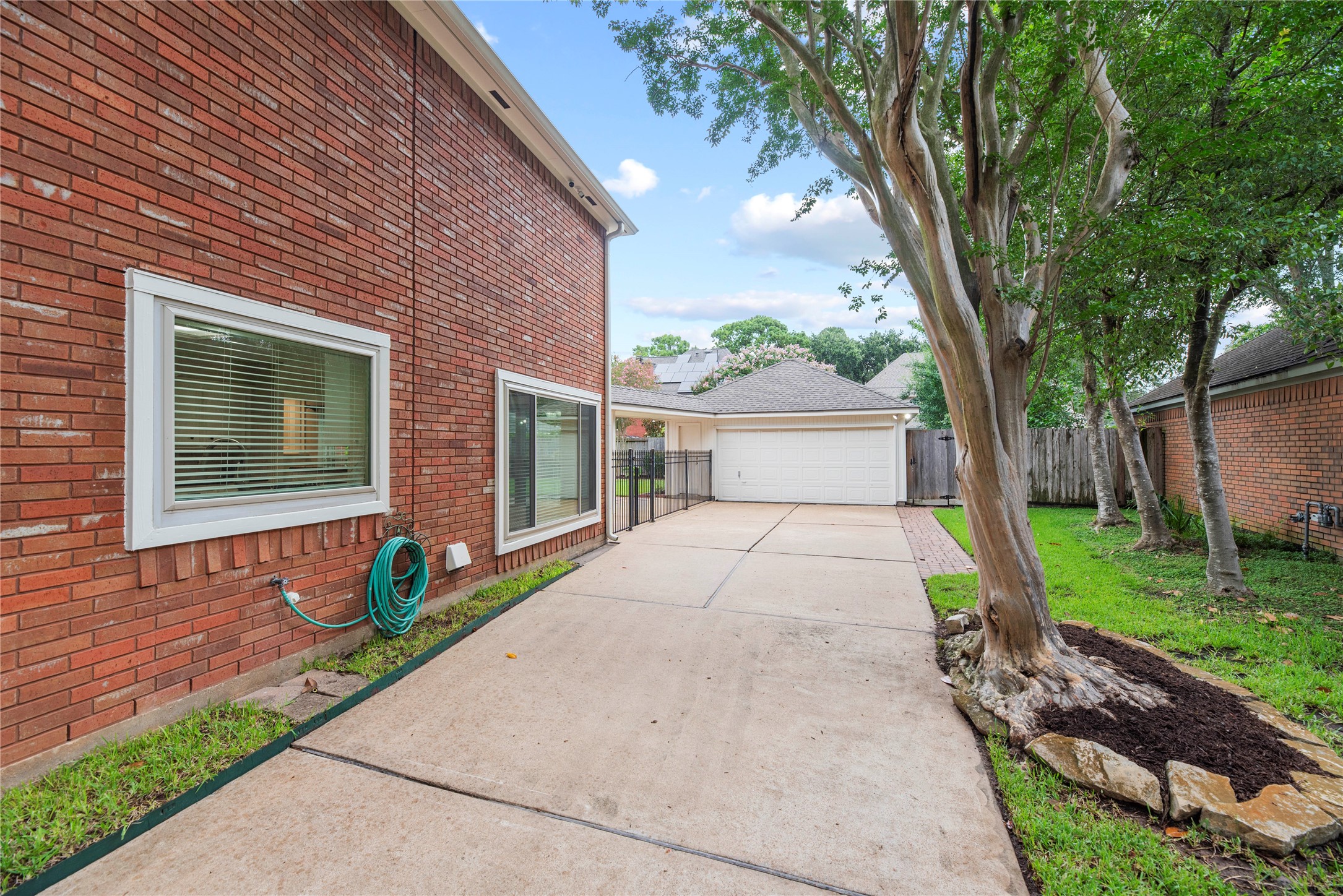 A long driveway leads to the detached 2-car garage with 3 remote openers, while a 2021 roof, vinyl double-pane windows including select sliders installed in Oct 2020, condenser units & evaporator coils replaced in June 2019, a full-yard sprinkler system & 4 wired outdoor cameras with app capability for remote monitoring add everyday convenience & peace of mind.
