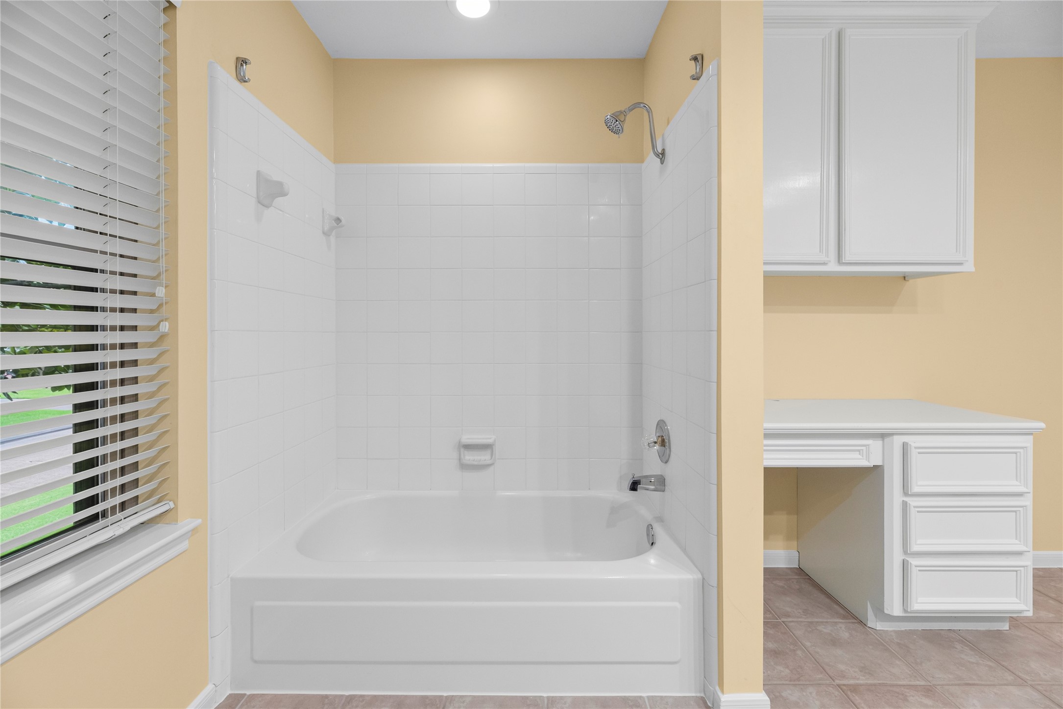 A second (dry) vanity adds another spot for morning routines, while the nearby hall closet provides extra storage for towels, linens and other daily essentials.