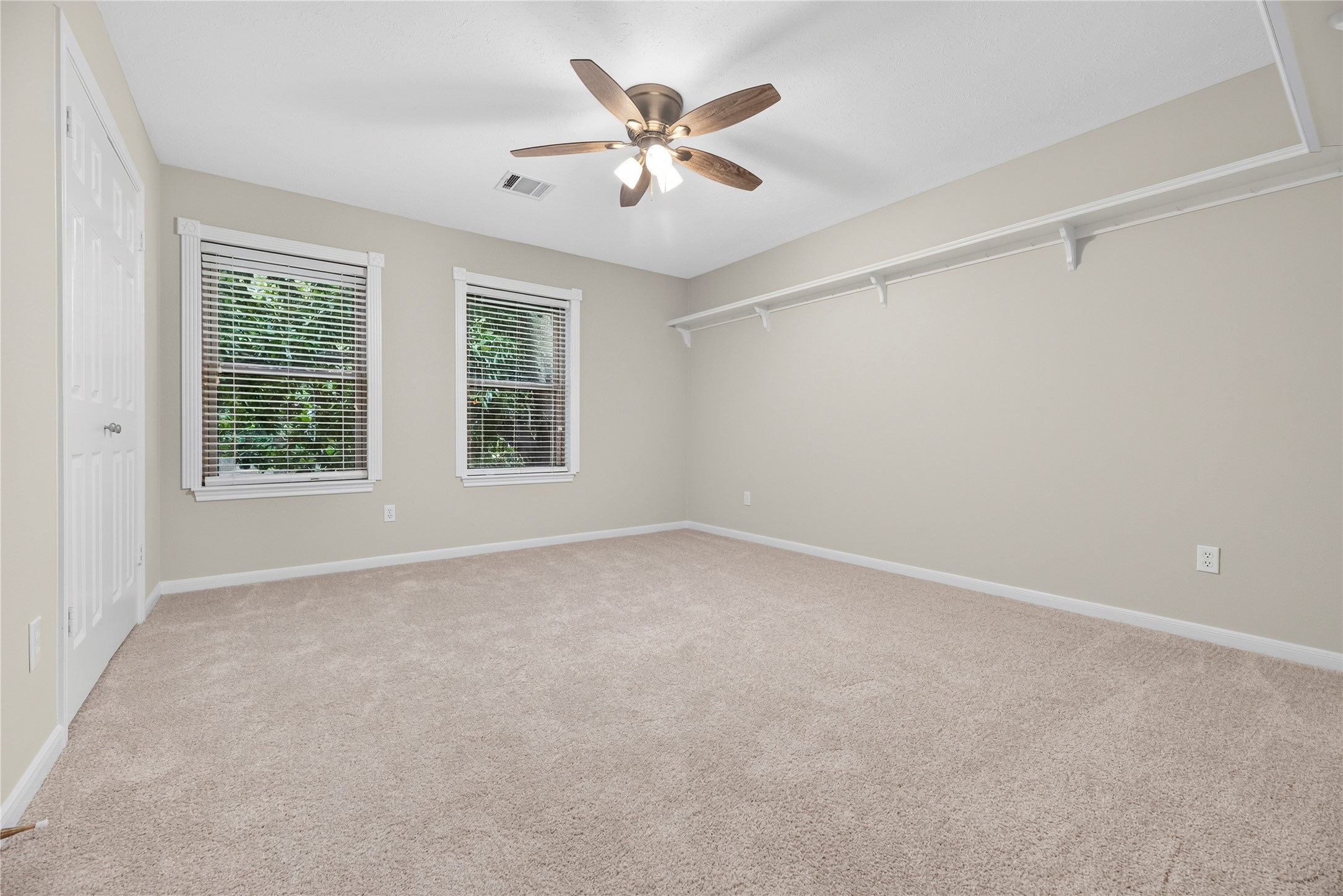 This inviting upstairs guest bedroom offers fresh paint and updated carpet (both in July 2026) & a large updated window that fills the space with natural light. Its a comfortable retreat for overnight guests. For added peace of mind, 3 combination smoke & carbon monoxide detectors were installed in Jan 2026 outside the bedroom areas.