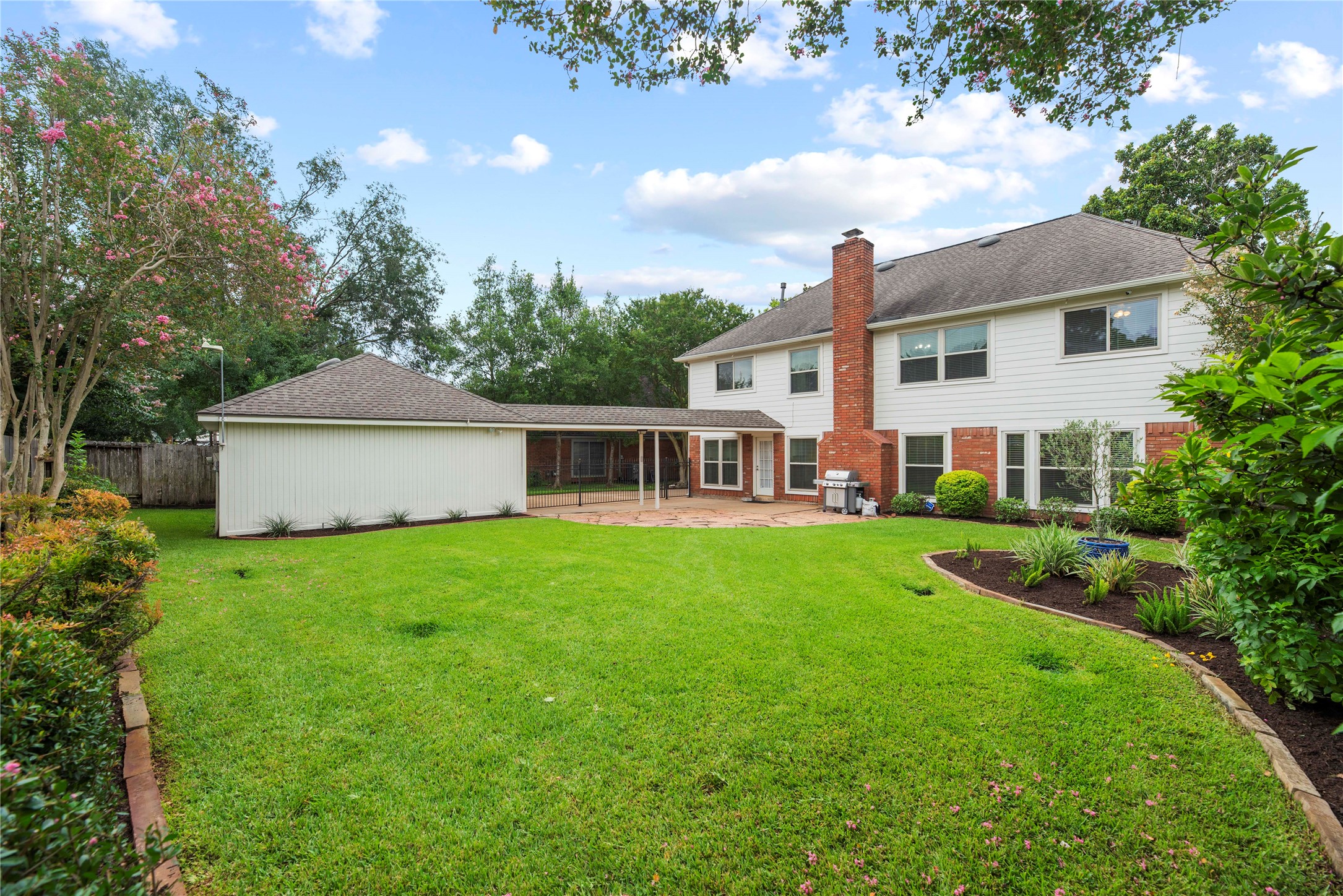 Bring the swing set, trampoline and all the favorite yard toys, then let the games begin. This expansive fenced backyard is ready for hours of outdoor fun.