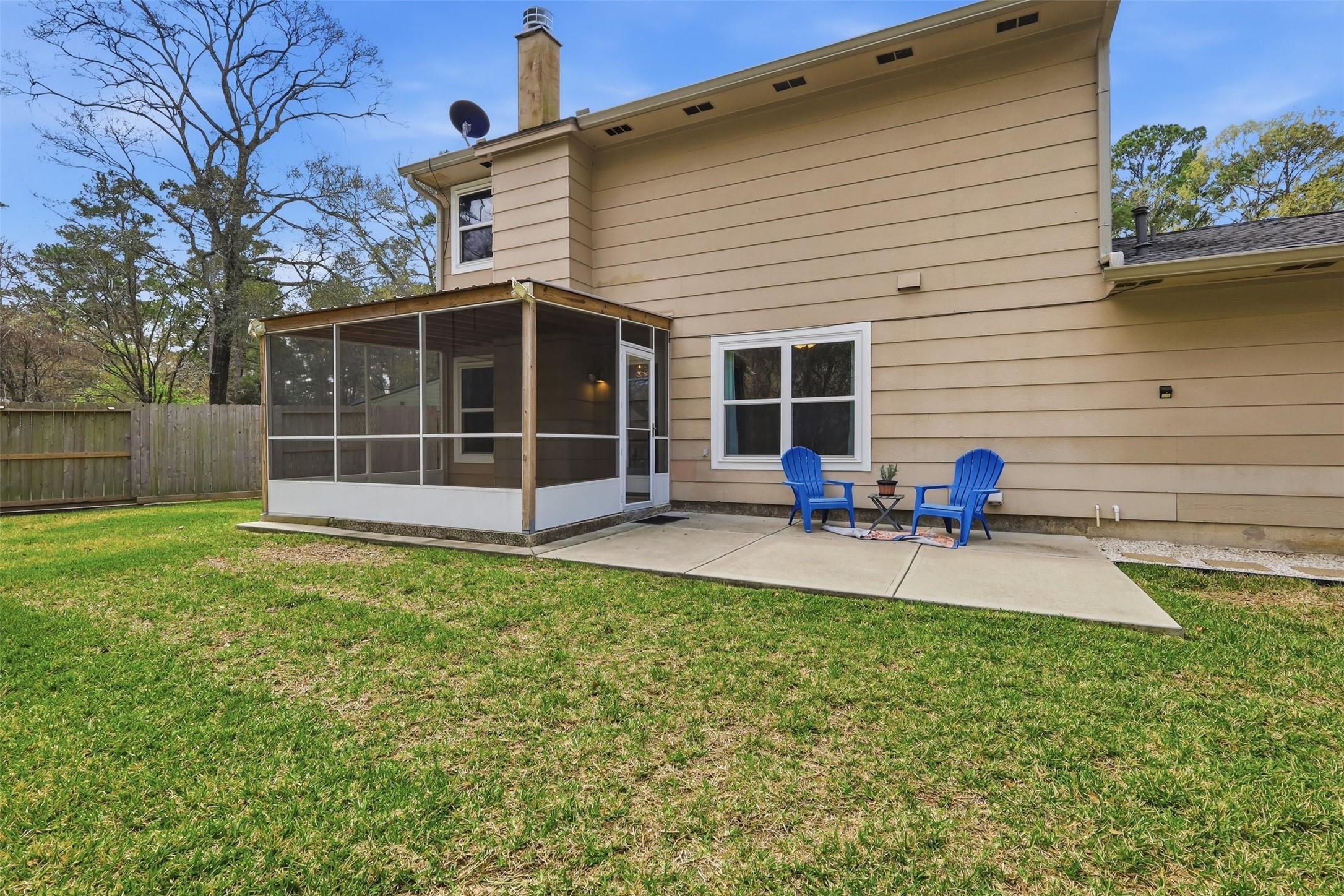 Enjoy the cozy backyard with a screened-in porch. The backyard offers a private and inviting entertainment space.
