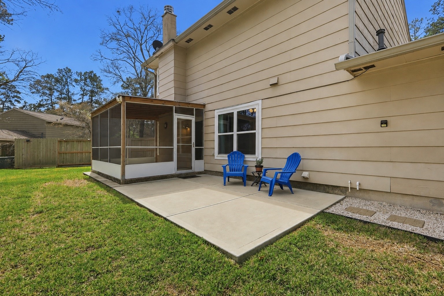 Spacious backyard patio with screened-in porch, offering the perfect blend of indoor and outdoor living.