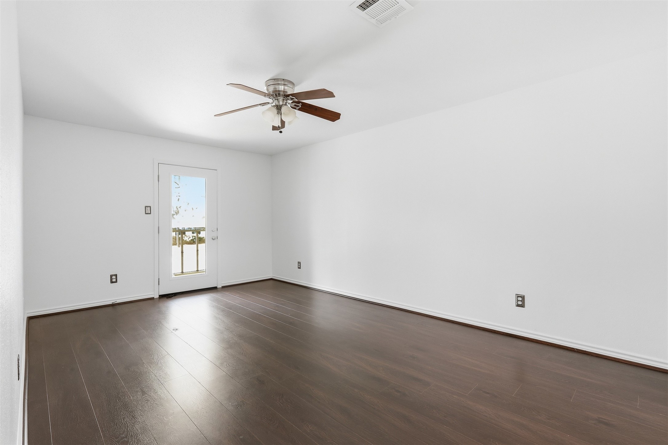 Primary bedroom with connected balcony access.