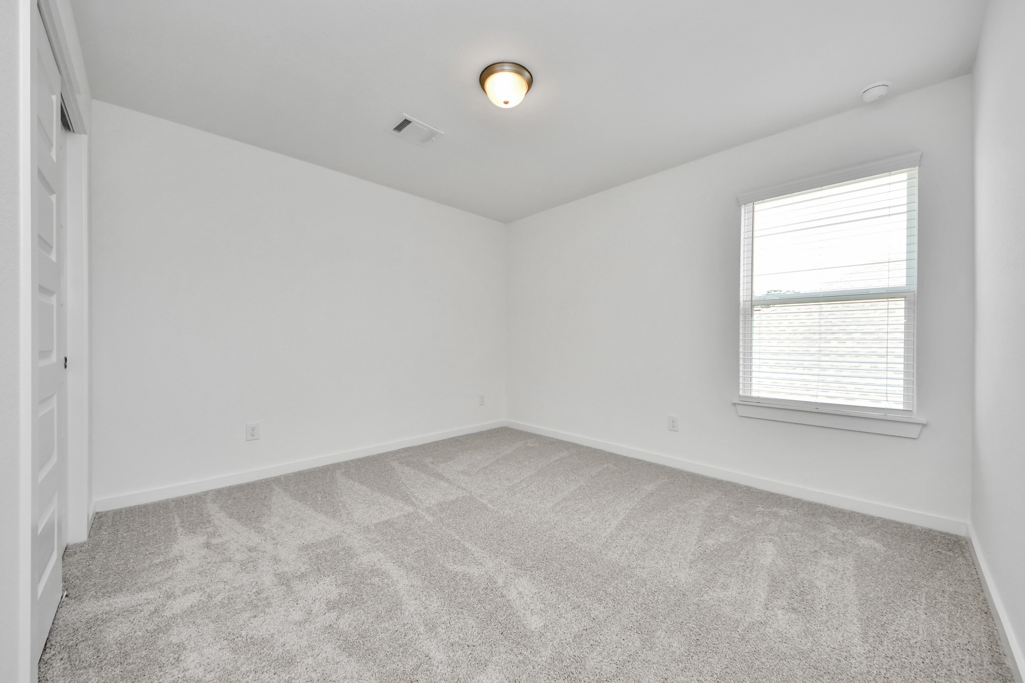 Generously sized secondary bedrooms featuring spacious closets, soft and inviting carpeting underfoot, large windows allowing plenty of natural light, and the added touch of privacy blinds for your personal retreat. Sample photo of completed home with similar floor plan. Actual colors and selections may vary.