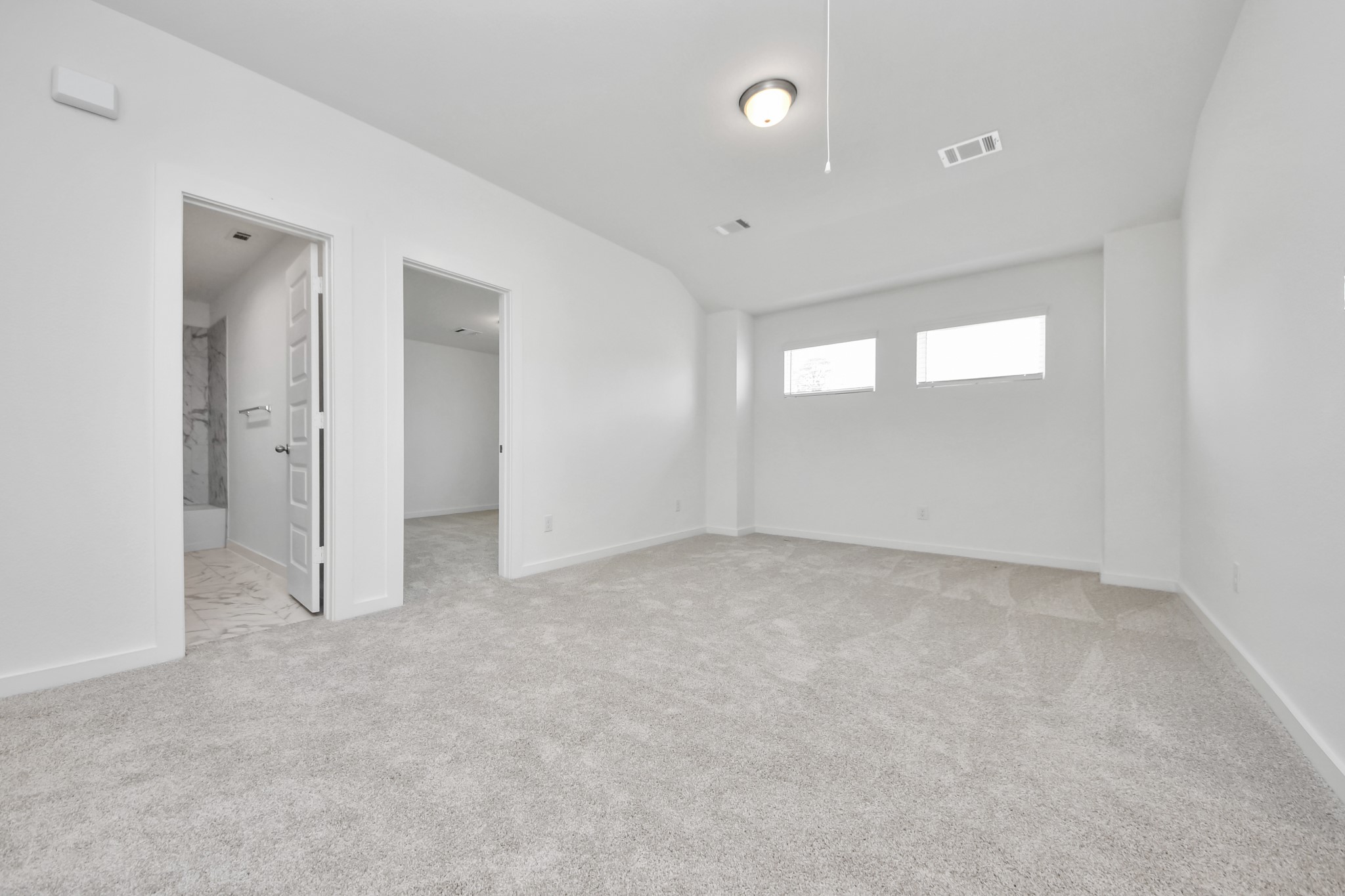 Discover a haven of leisure in this fantastic game room! Whether you're seeking a casual hangout or an adult gaming retreat, this space has it all. Enjoy the luxurious feel of plush carpet underfoot, the expansive ambiance of high ceilings, custom paint that adds a touch of personality, and windows that flood the room with refreshing natural light. Sample photo of completed home with similar floor plan. Actual colors and selections may vary.