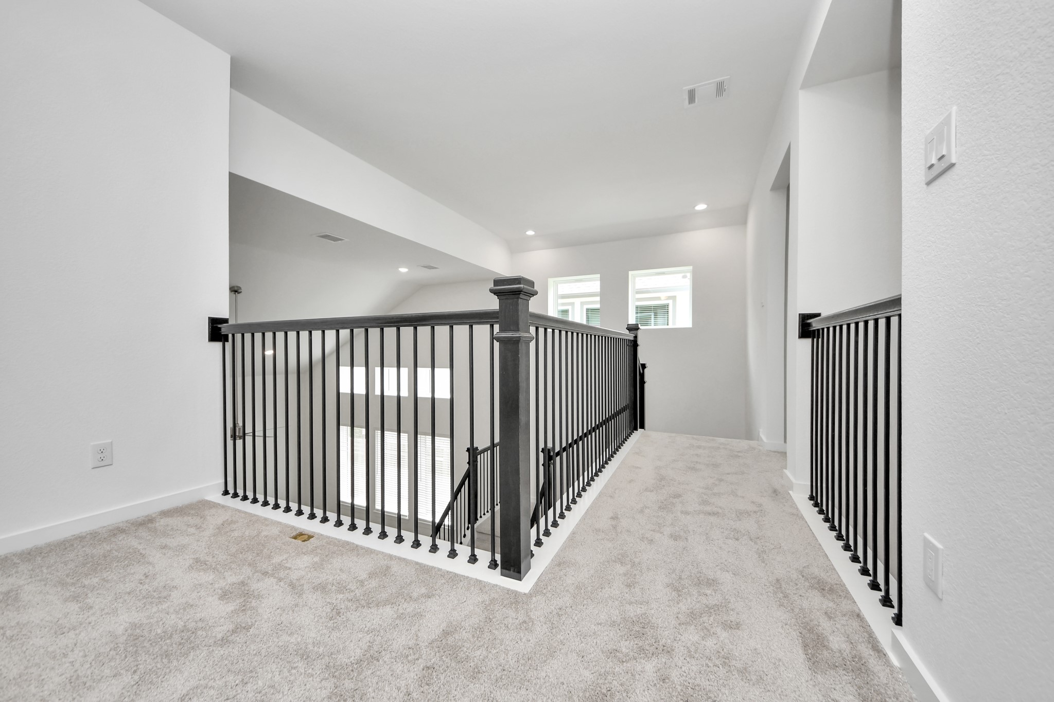 Ascend to relaxation in this fantastic game room! Ideal for both casual gatherings and adult gaming, it boasts plush carpet, lofty ceilings, custom paint, and ample windows for abundant natural light. Sample photo of completed home with similar floor plan. Actual colors and selections may vary.