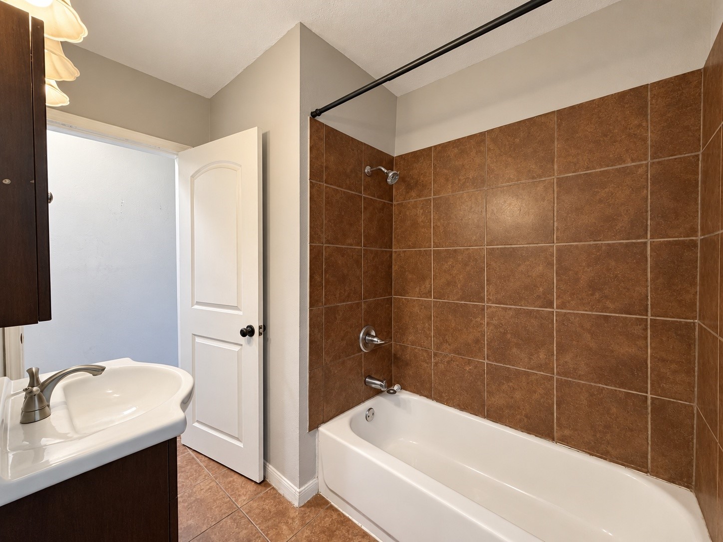 Full bathroom (6x8) with a tub/shower combo and tile surround.