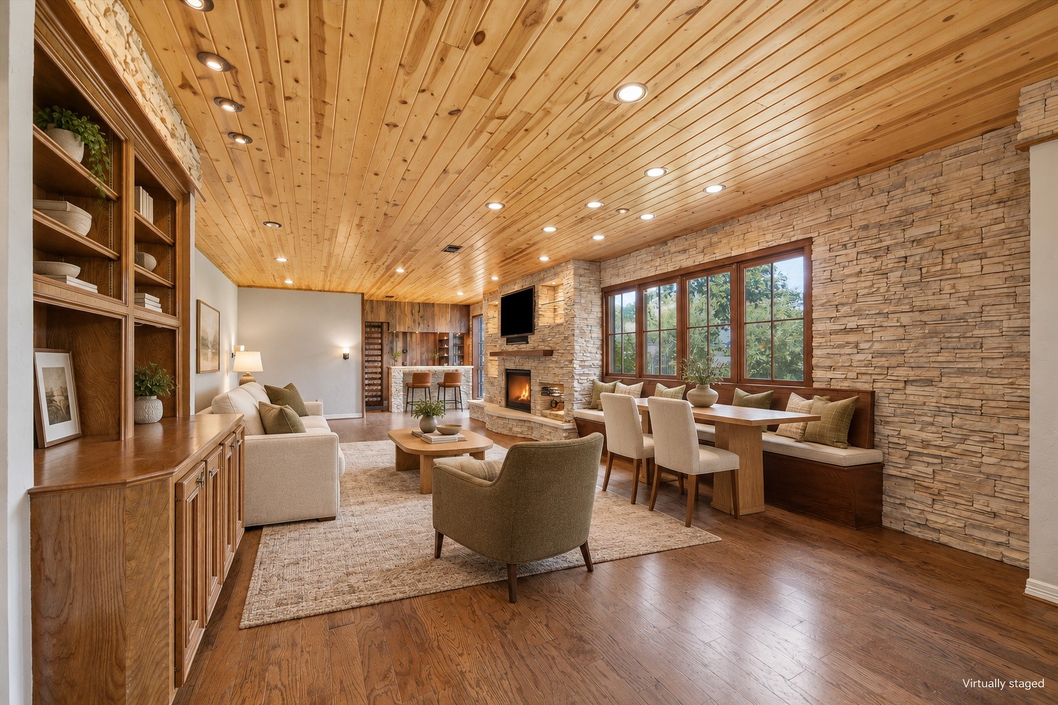 Virtually staged to show the living, dining and bar.