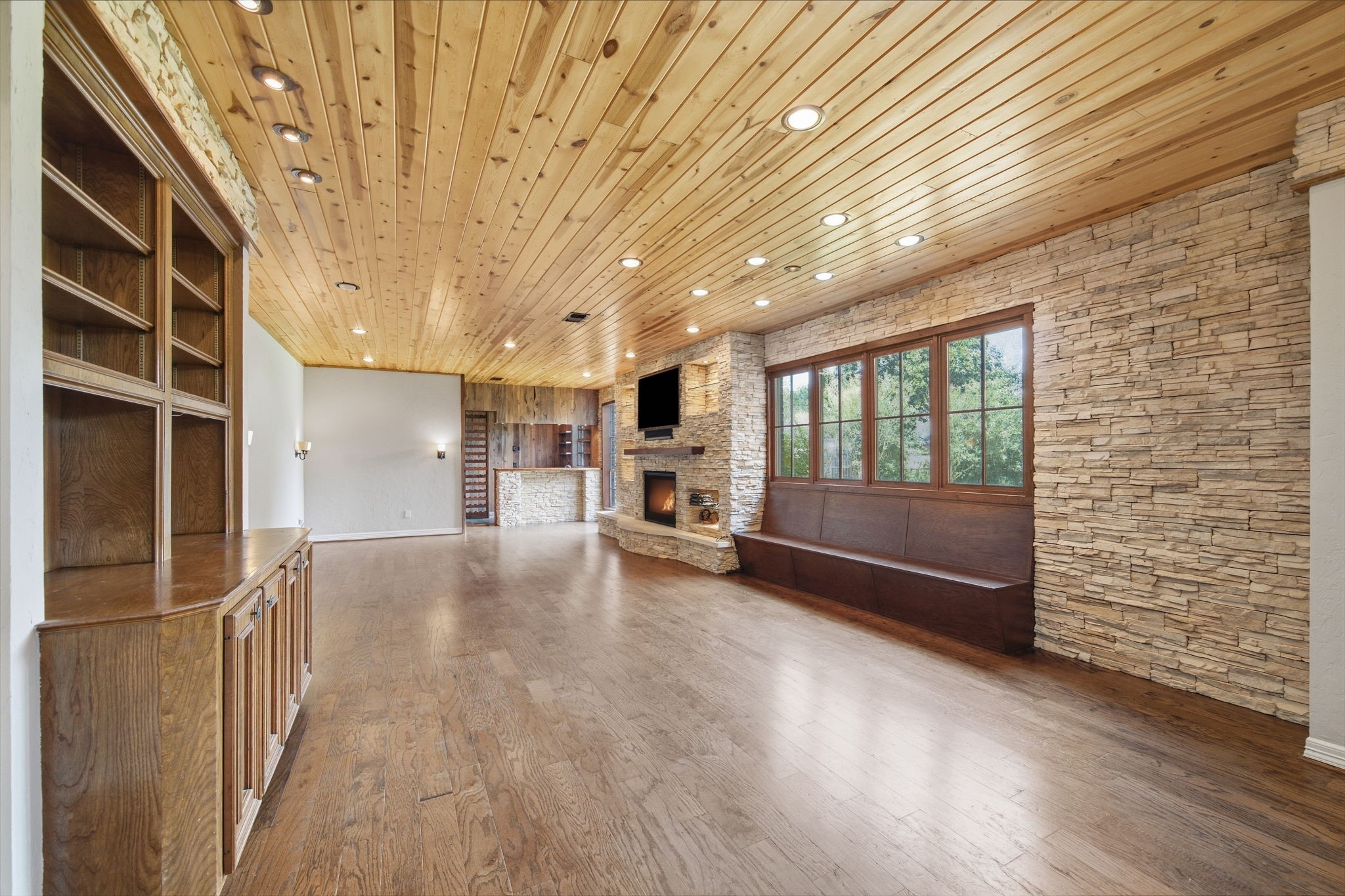 The expansive living room stretches more than 32 feet, providing incredible flexibility for multiple conversation, entertaining, or sitting areas. Warm finishes create an inviting first impression while offering a glimpse into the home's one-of-a-kind character.