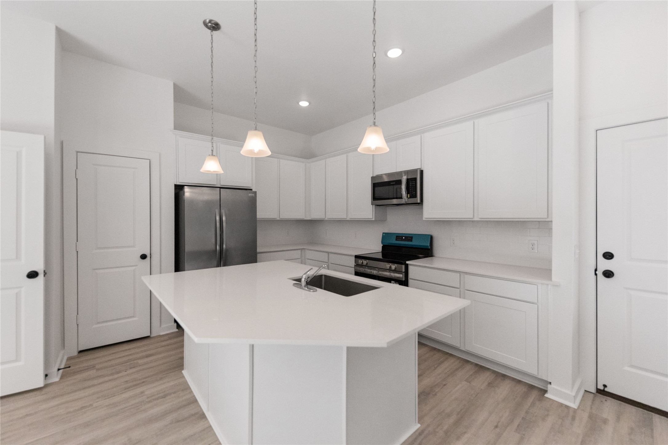 Kitchen with white quartz countertops