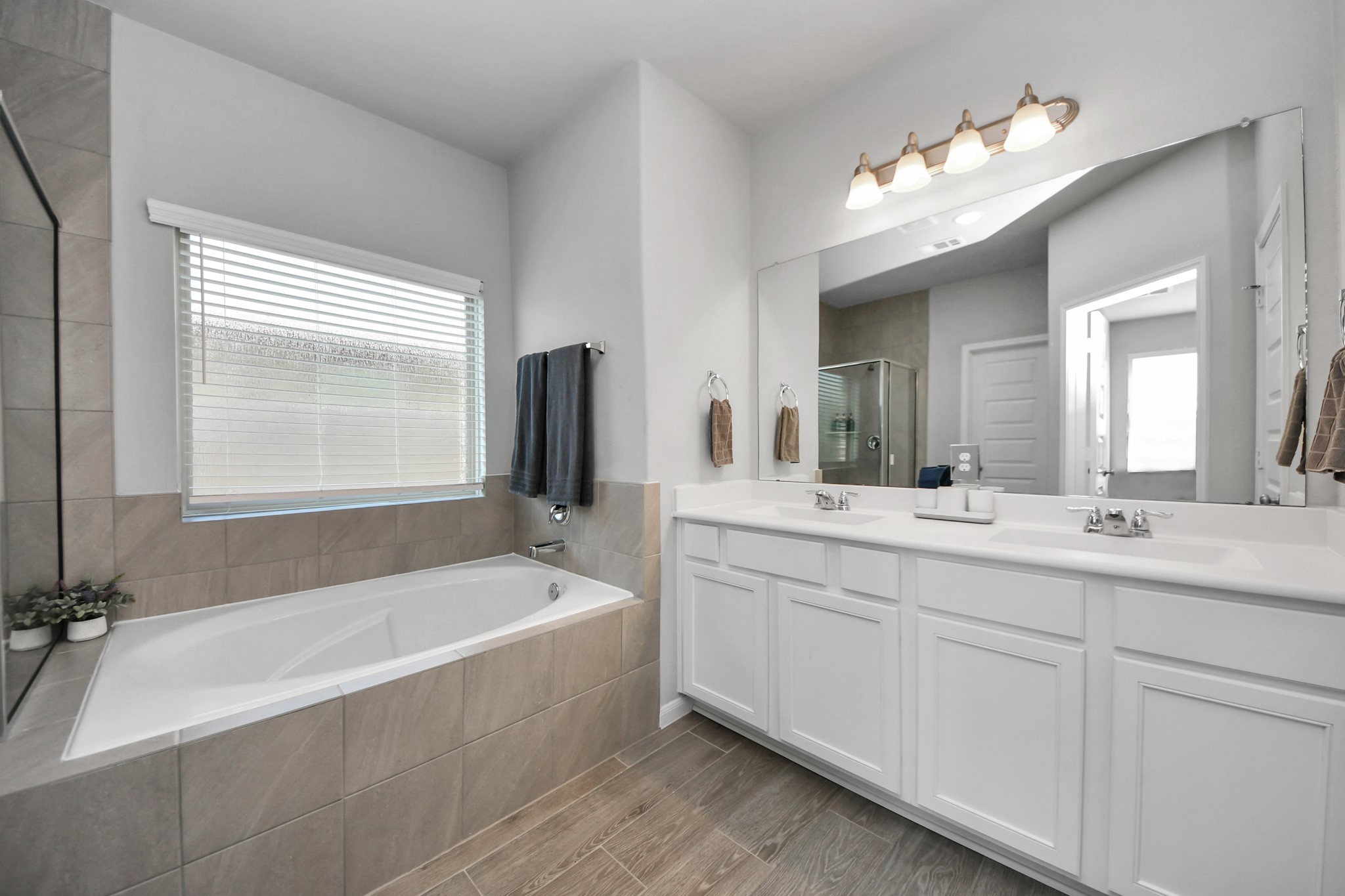 Primary bath with double vanity, full tub and shower