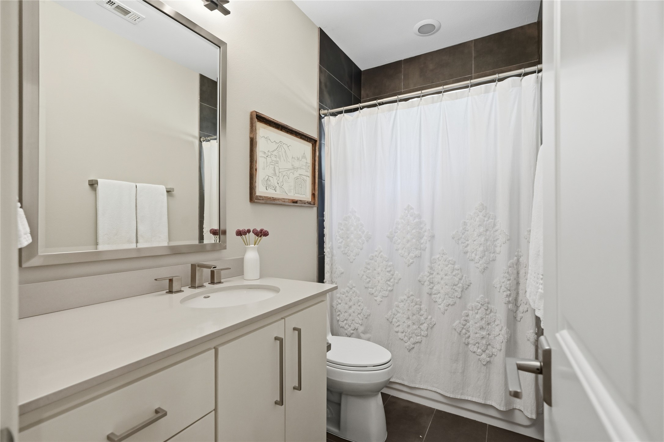 Upstairs full bathroom features a spacious vanity, contemporary finishes, and a shower/tub combination.
