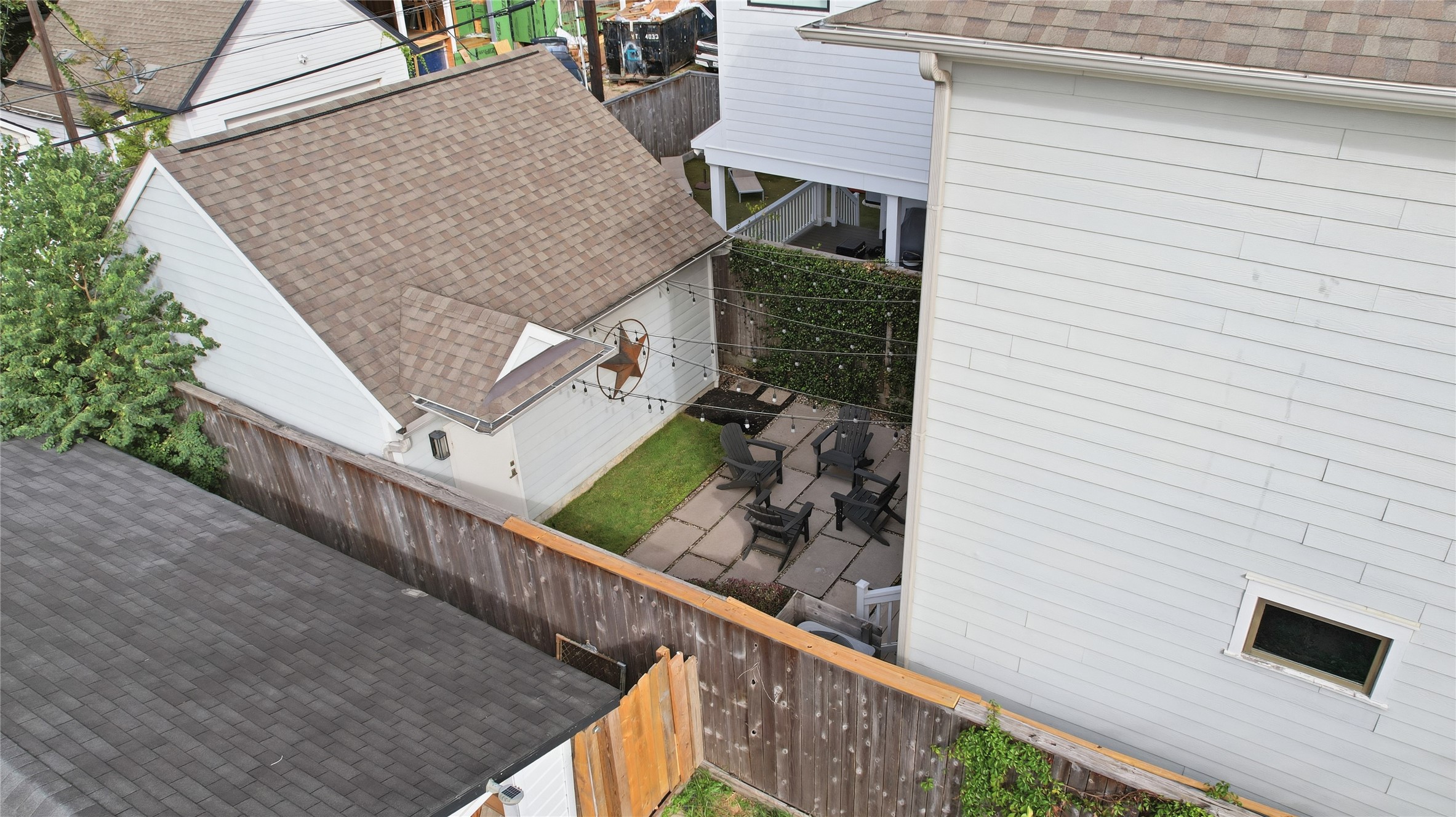 Fully fenced and thoughtfully designed, the backyard provides a charming gathering space.