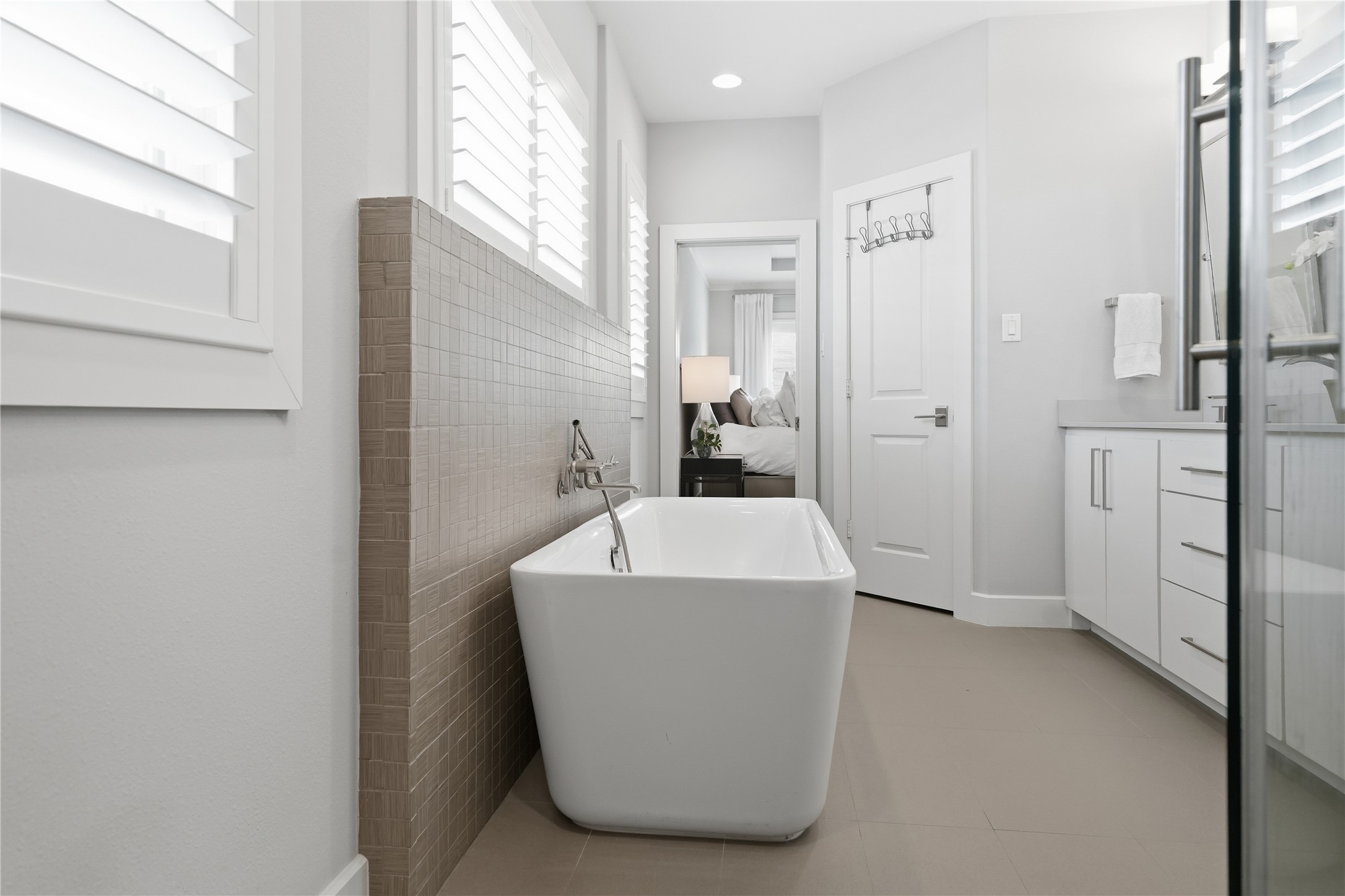 Designed for relaxation, the elegant freestanding soaking tub provides a luxurious retreat within the primary bath.