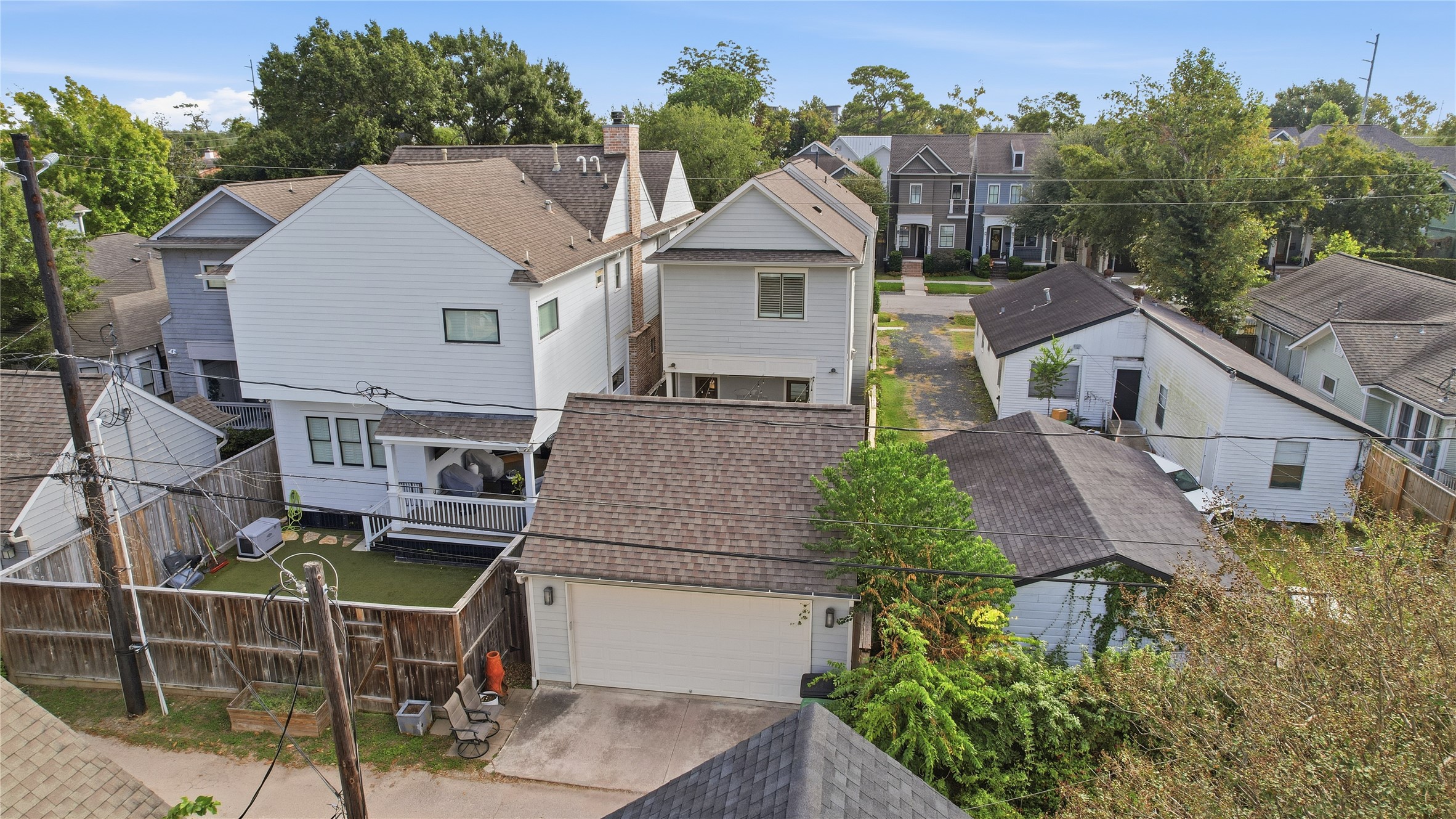 Detached two-car garage provides secure parking and additional storage, with convenient rear alley access.