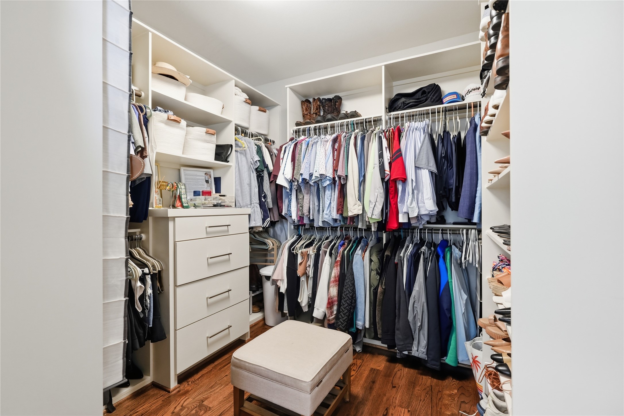 Designed for functionality, the oversized primary closet offers extensive shelving, built-in drawers, and abundant hanging space.