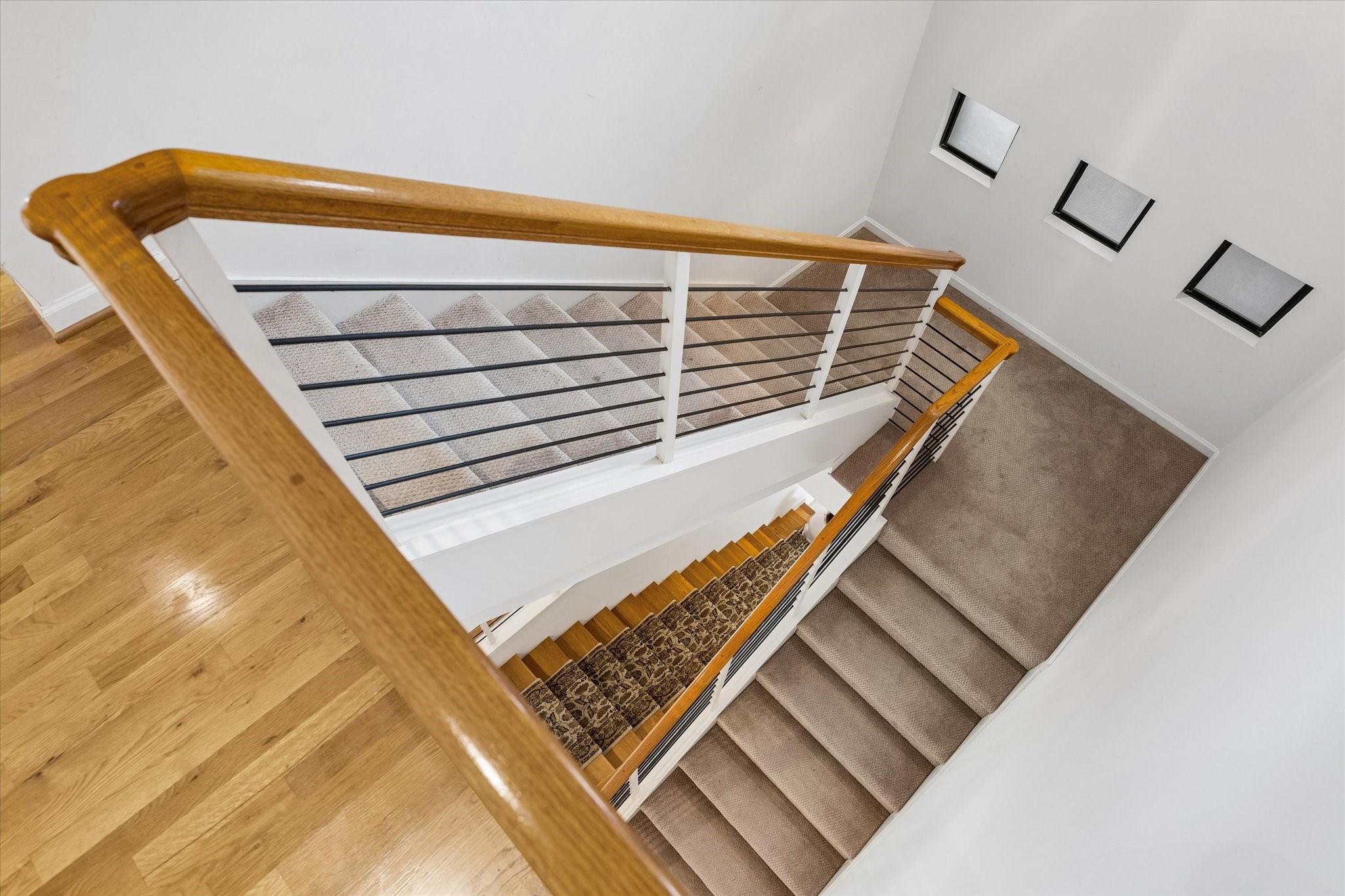 I PERSONALLY LOVE THE DESIGN OF THE STAIRCASE.  LOOKS VERY MODERN, SLICK AND IN TODAYS STYLE.  THIS COULD BE A FRAMED PICTURE, IT IS SO PERFECT.