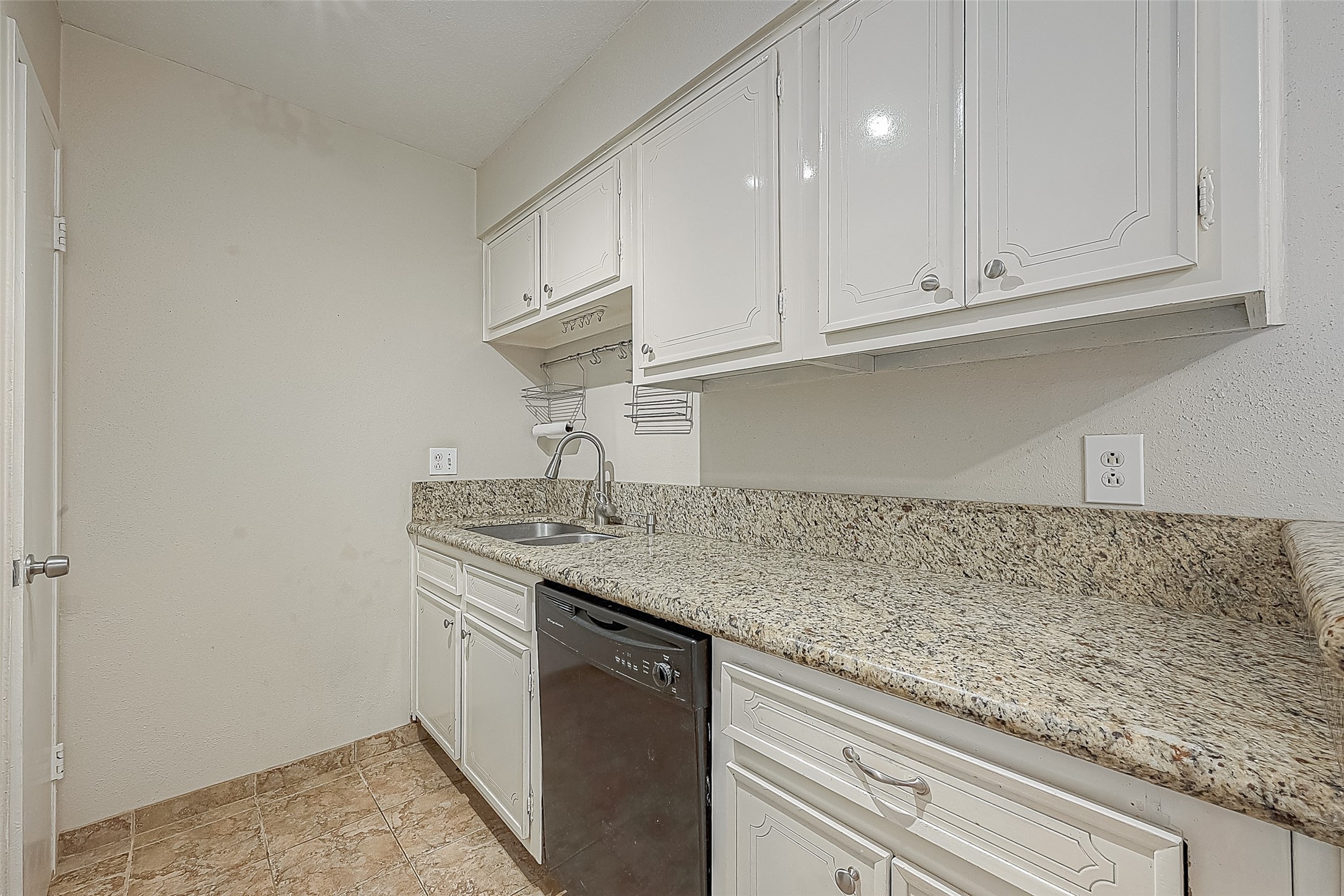 Granite countertops provide plenty of prep space, while white cabinetry offers storage above & below. Kitchen also features a double stainless steel sink & dishwashermaking meal prep and clean-up a breeze!