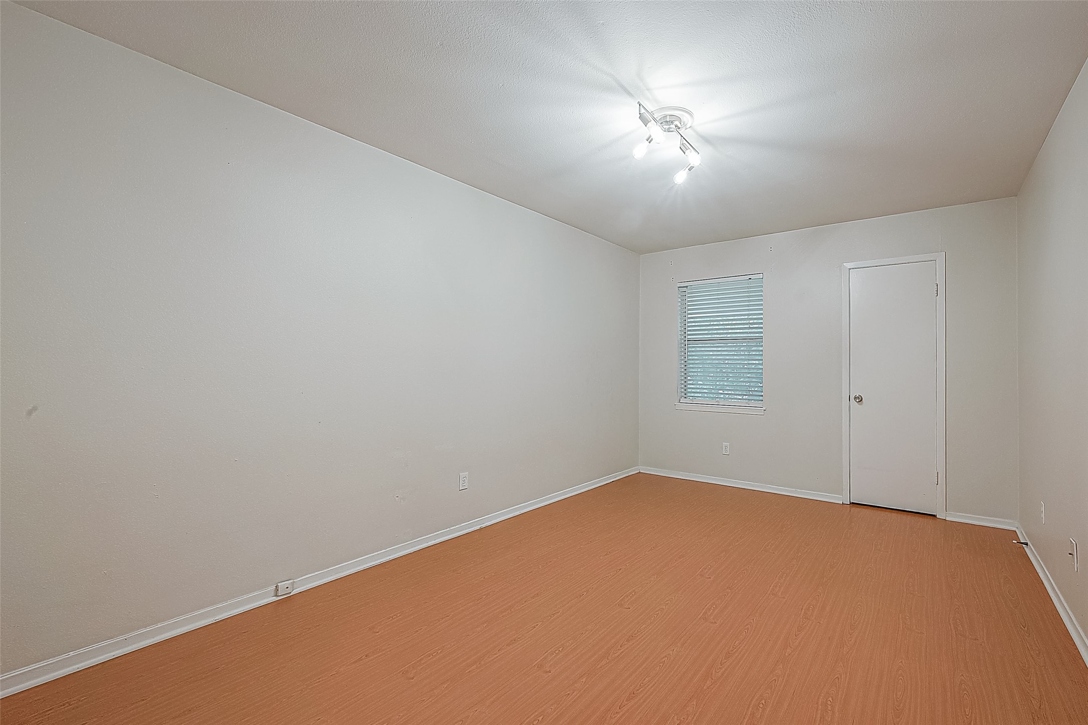 The primary bedroom is a SPACIOUS 15.1 x 10.6 with engineered wood flooring & updated track lighting. Theres plenty of room for a king-size bedroom suite, plus excellent wall space for additional furniture. And yestheres a walk-in closet, too!