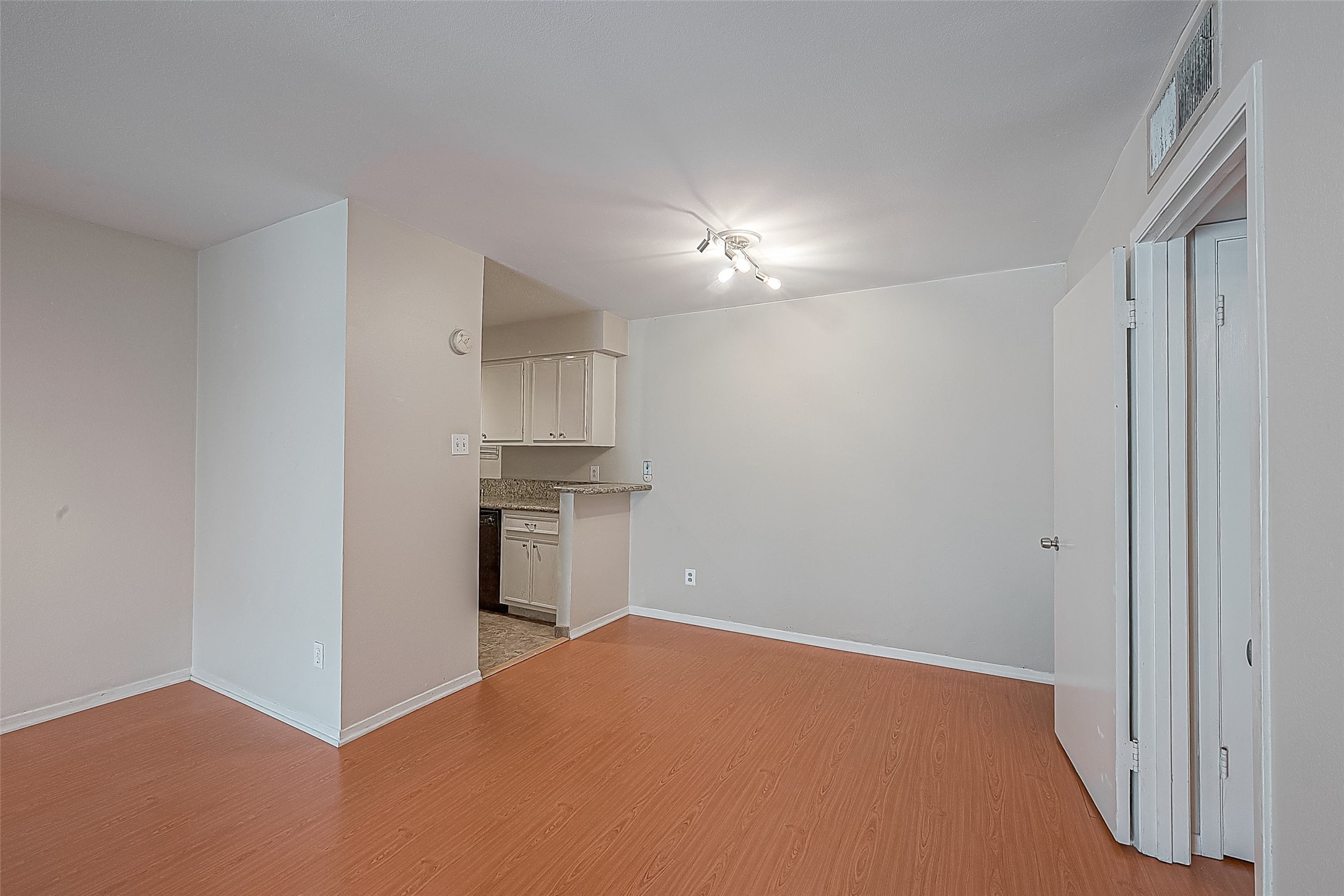 Dining area measures 7.9 x 7.6 and offers plenty of flexibility. Add a table for everyday meals, or repurpose the space as a home office or studythe choice is yours! Engineered wood flooring continues from the living room, creating a nice flow between the two spaces.